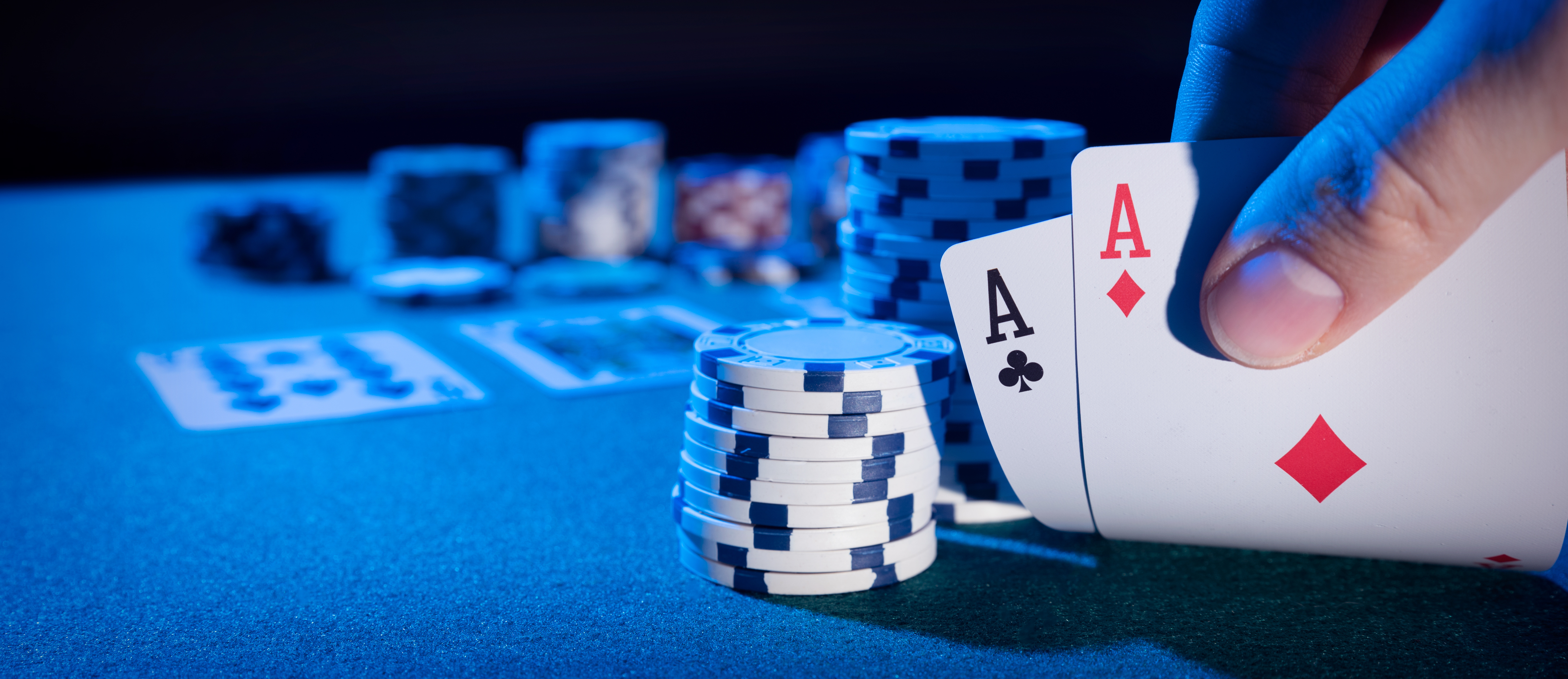 A poker player is revealing their hand to enhance the gaming experience in Nashua