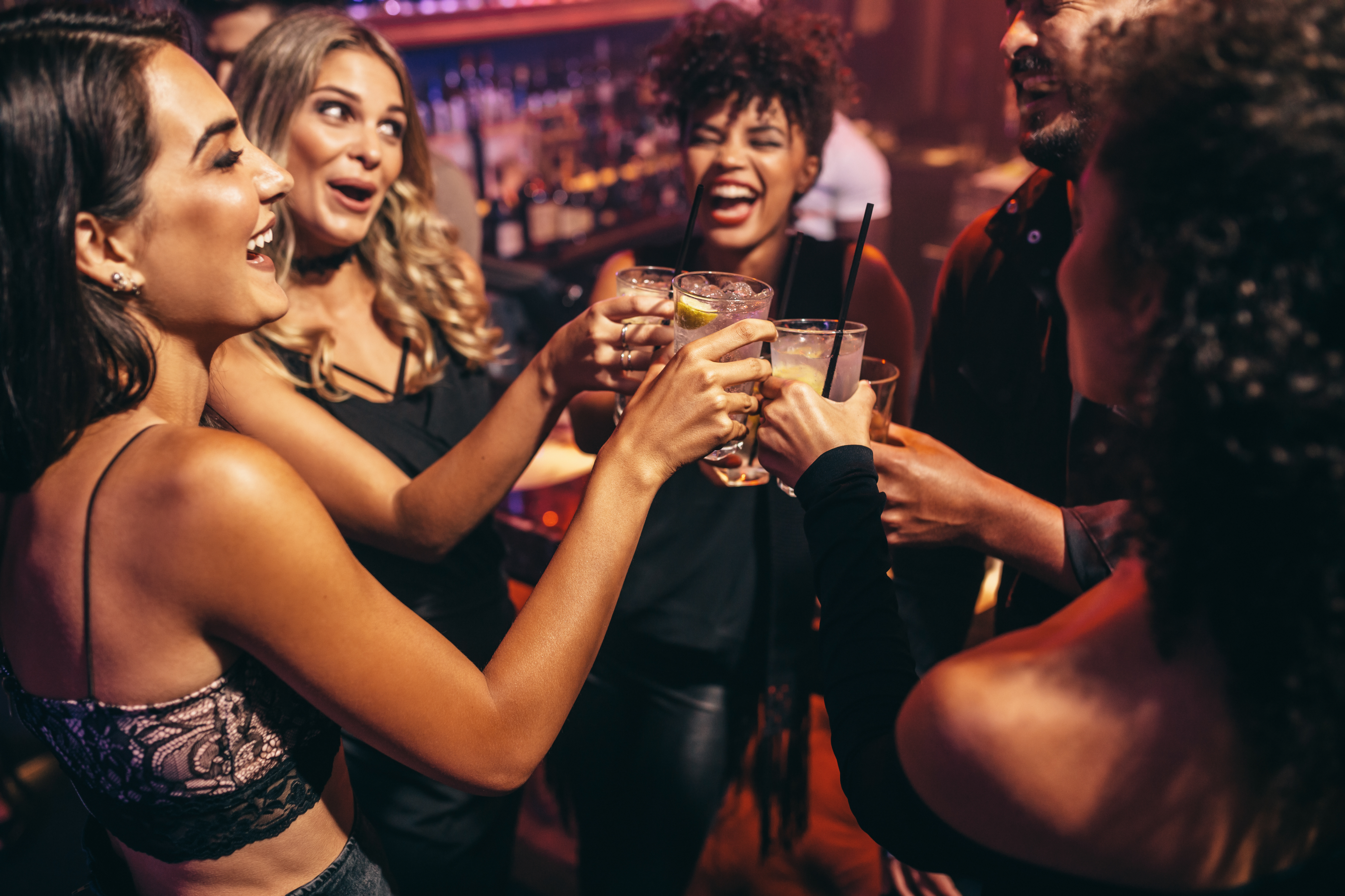 People toasting with different cocktails while enjoying live entertainment in Nashua, NH.