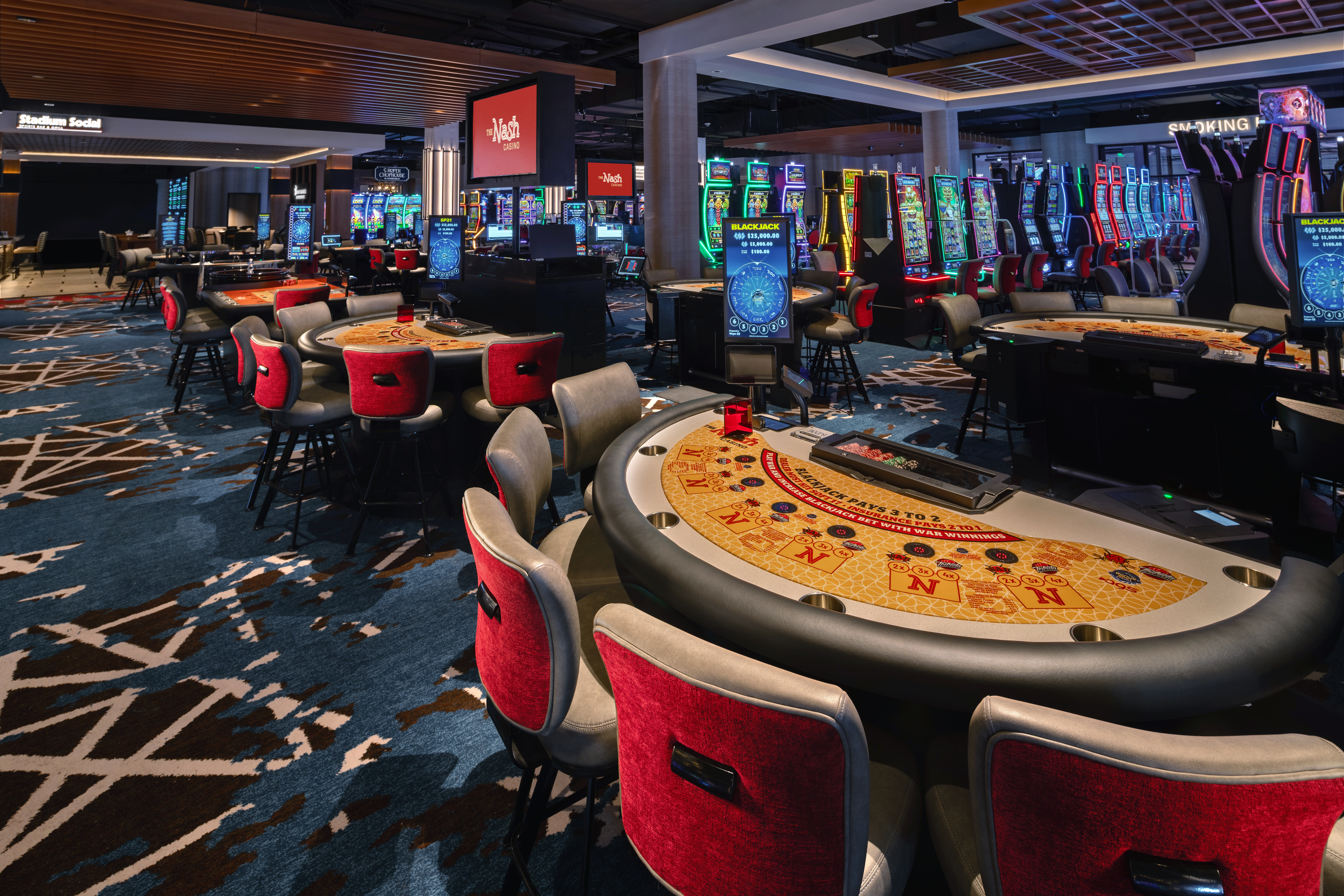 A casino gaming floor with gaming machines to represent how charitable casinos support community events in Nashua