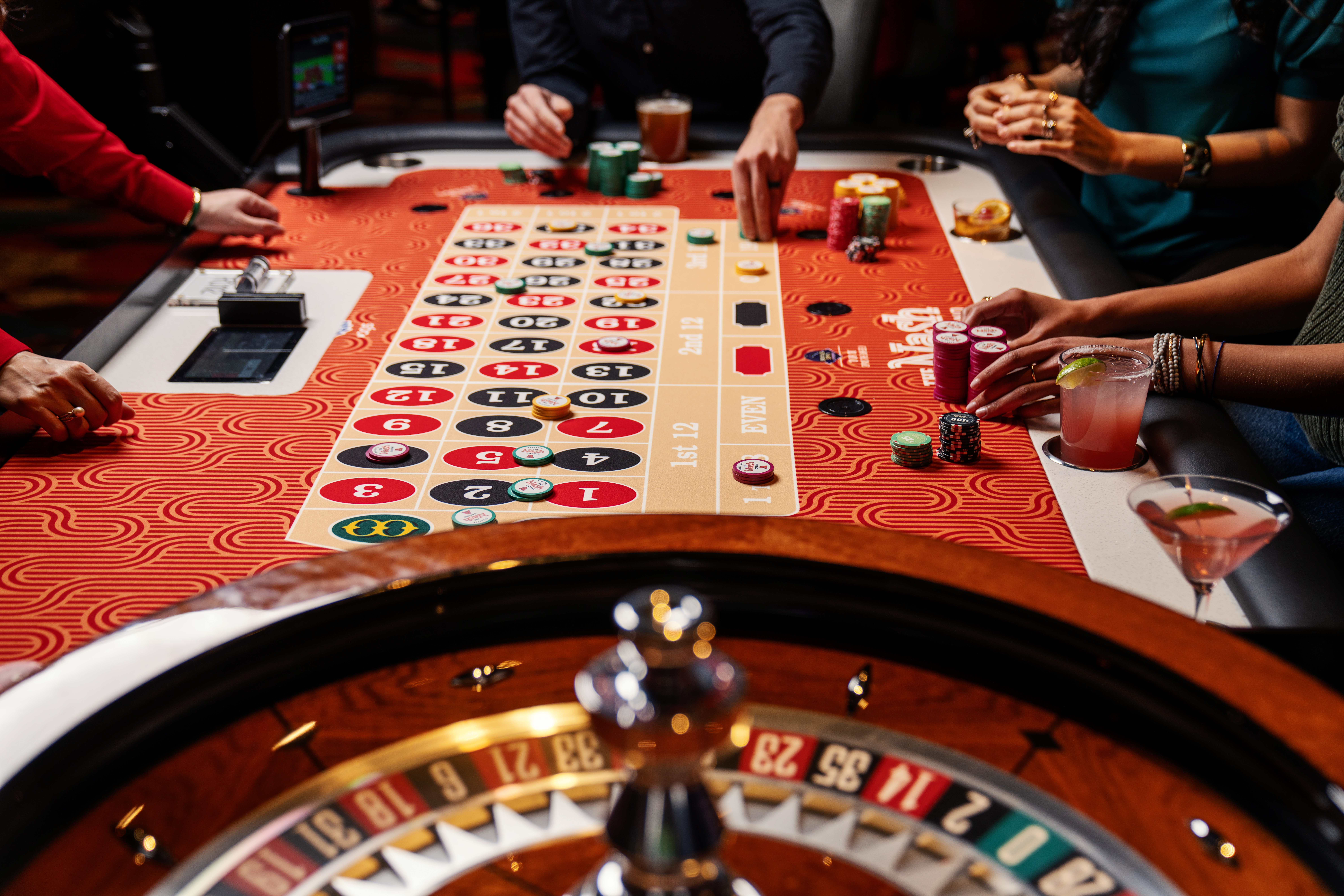 Players betting on a game of roulette at The Nash Casino
