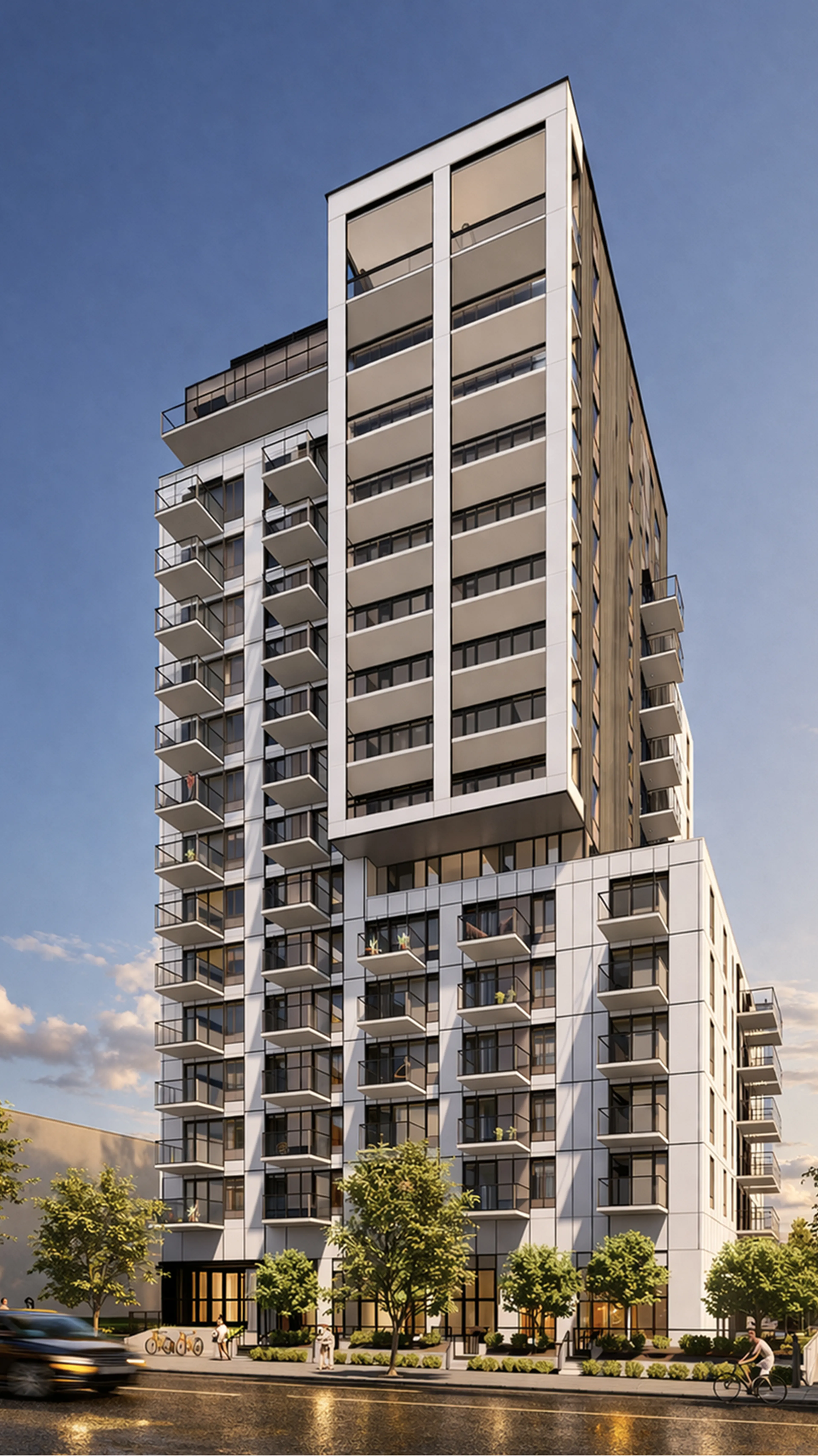 Modern high-rise apartment building with numerous balconies, large windows, and street-level greenery, situated under a clear blue sky.