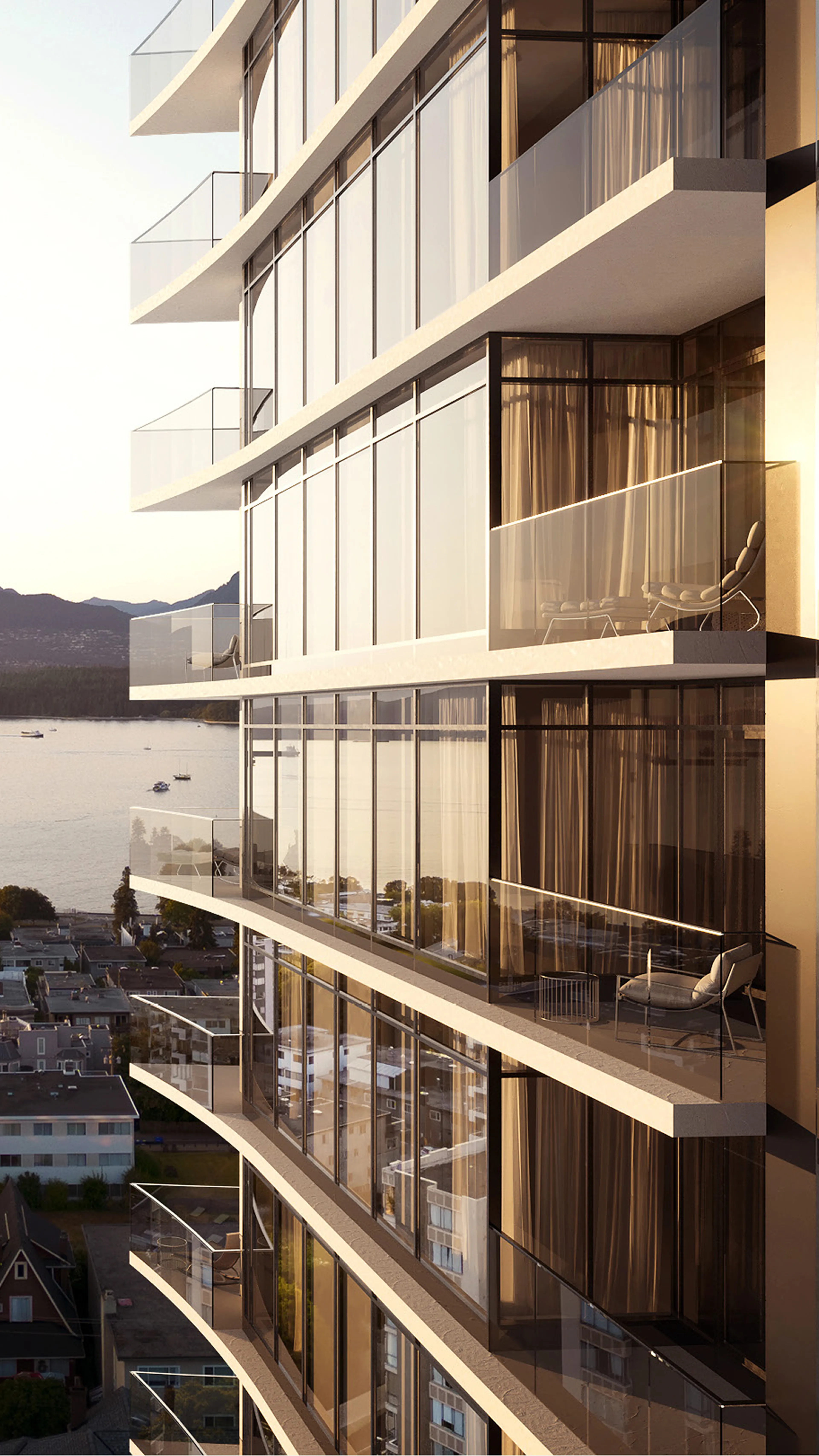 Modern high-rise building with glass balconies reflecting sunset light, overlooking a cityscape and calm water with distant hills.