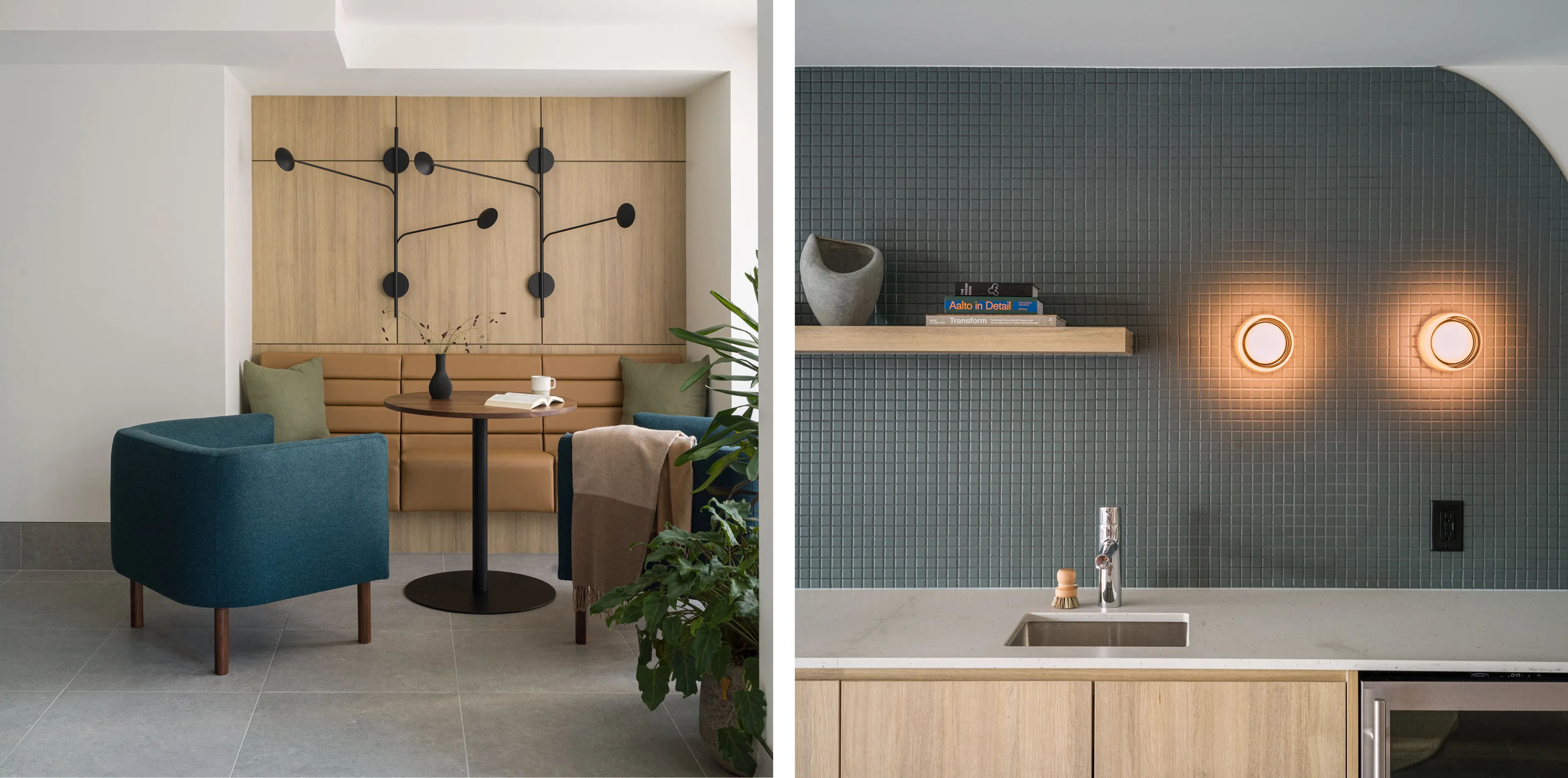 A modern seating area with a table and chairs, next to a minimal kitchen sink with a shelf and a tiled wall with warm lighting.