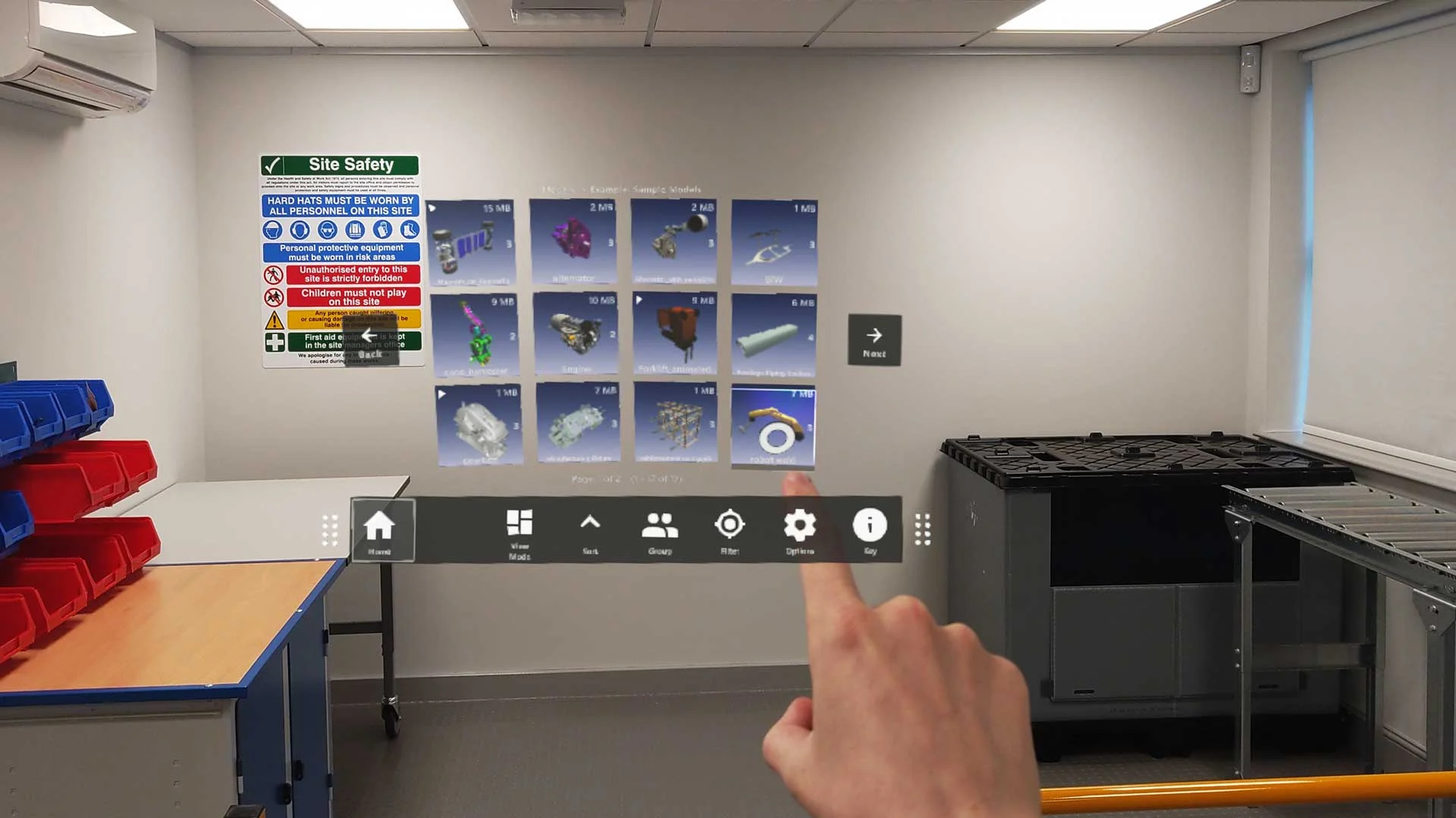 An engineer interacts with the SpinFireXR interface displaying, multiple 3D models