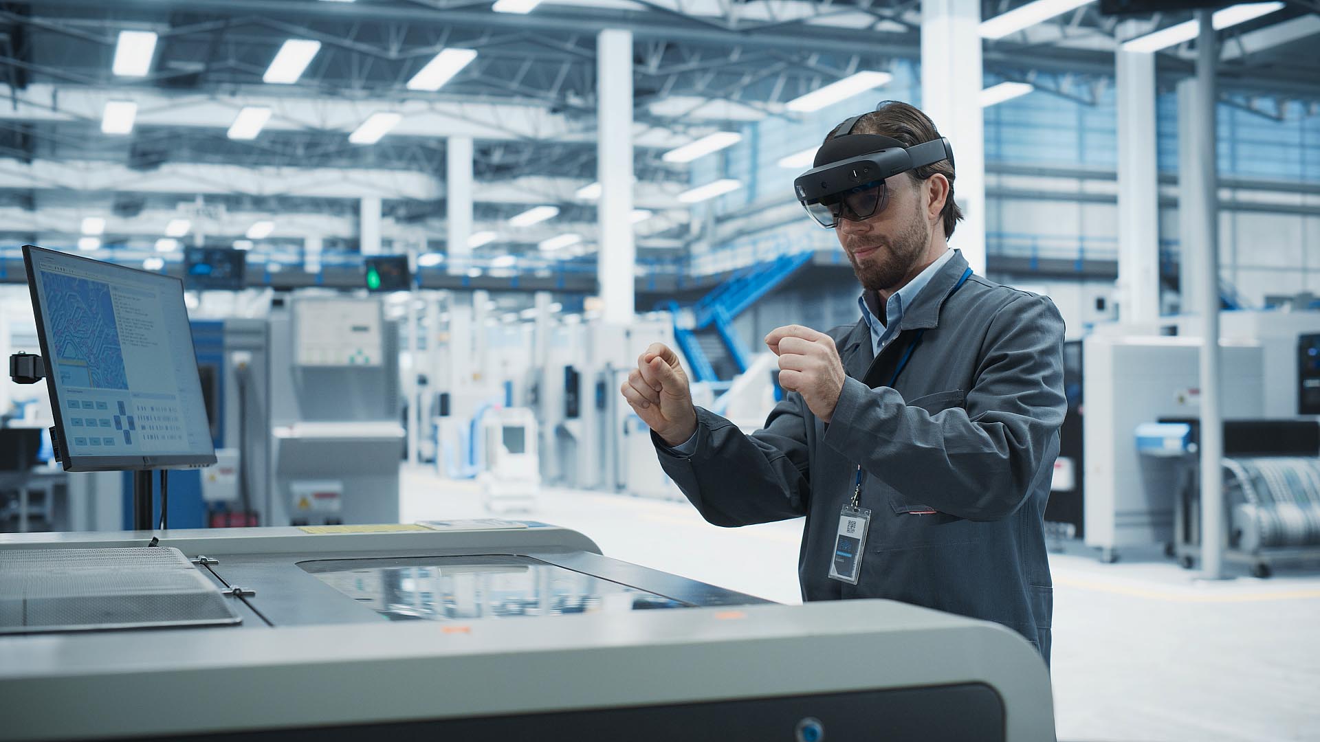 A man wearing an augmented mixed reality headset to visualize a model using hands.