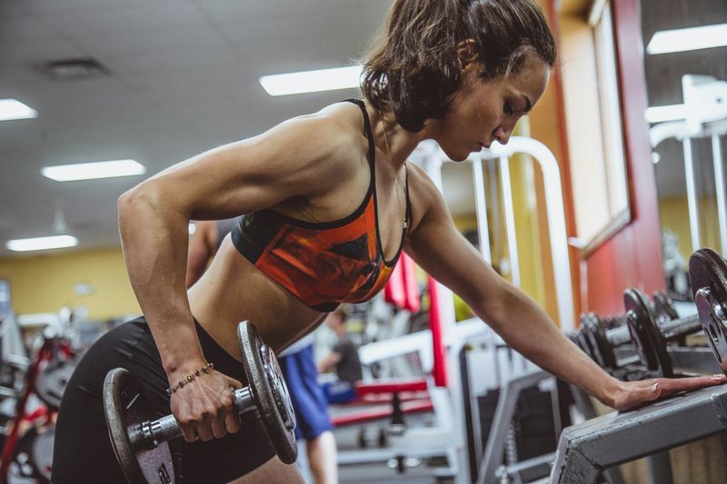 woman in gym - Weighted Dips Strength Standards