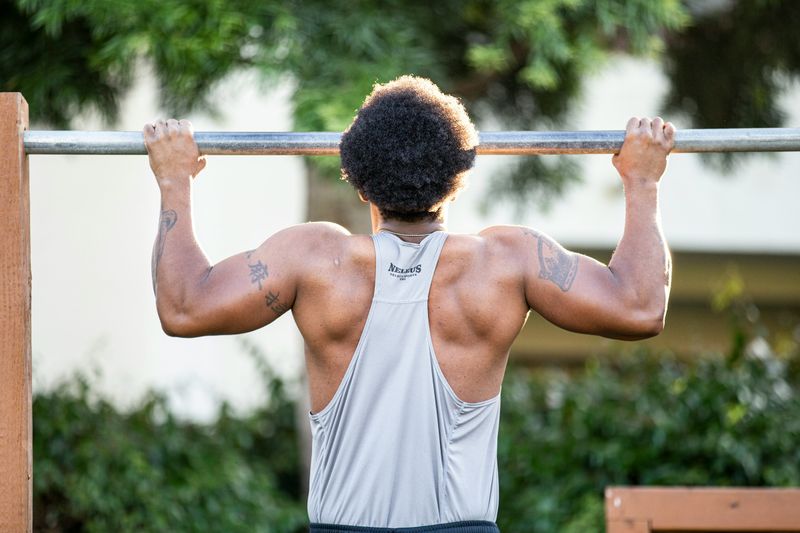man doing pull up - How Many Pull-Ups Can the Average Person Do