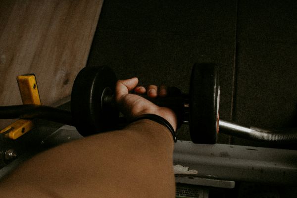 man holding dumbbells - Grip Strength Standards
