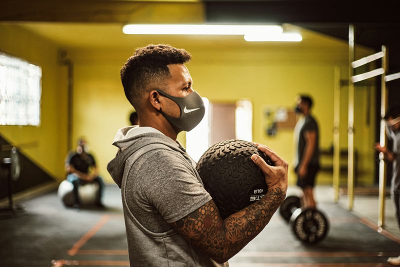 man holding gym ball - Grip Strength Standards