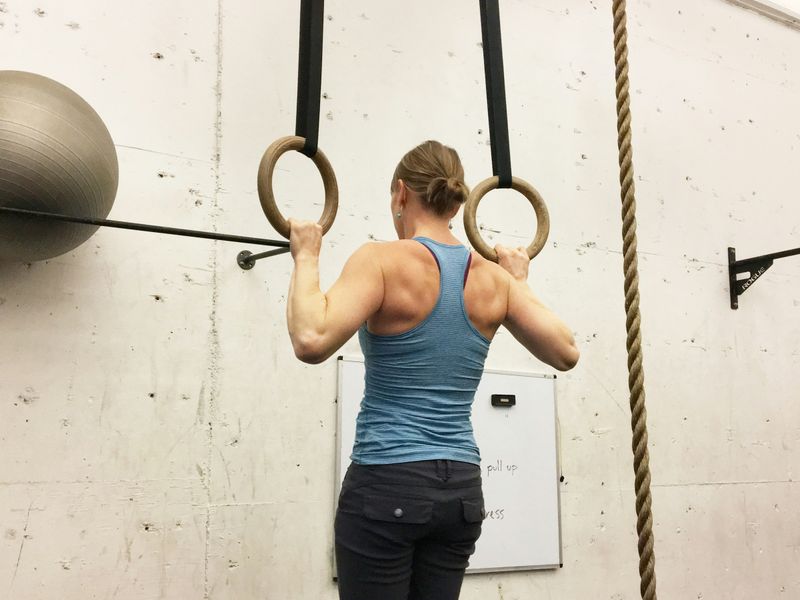 woman doing pull ups - Pull-Up Strength Standards