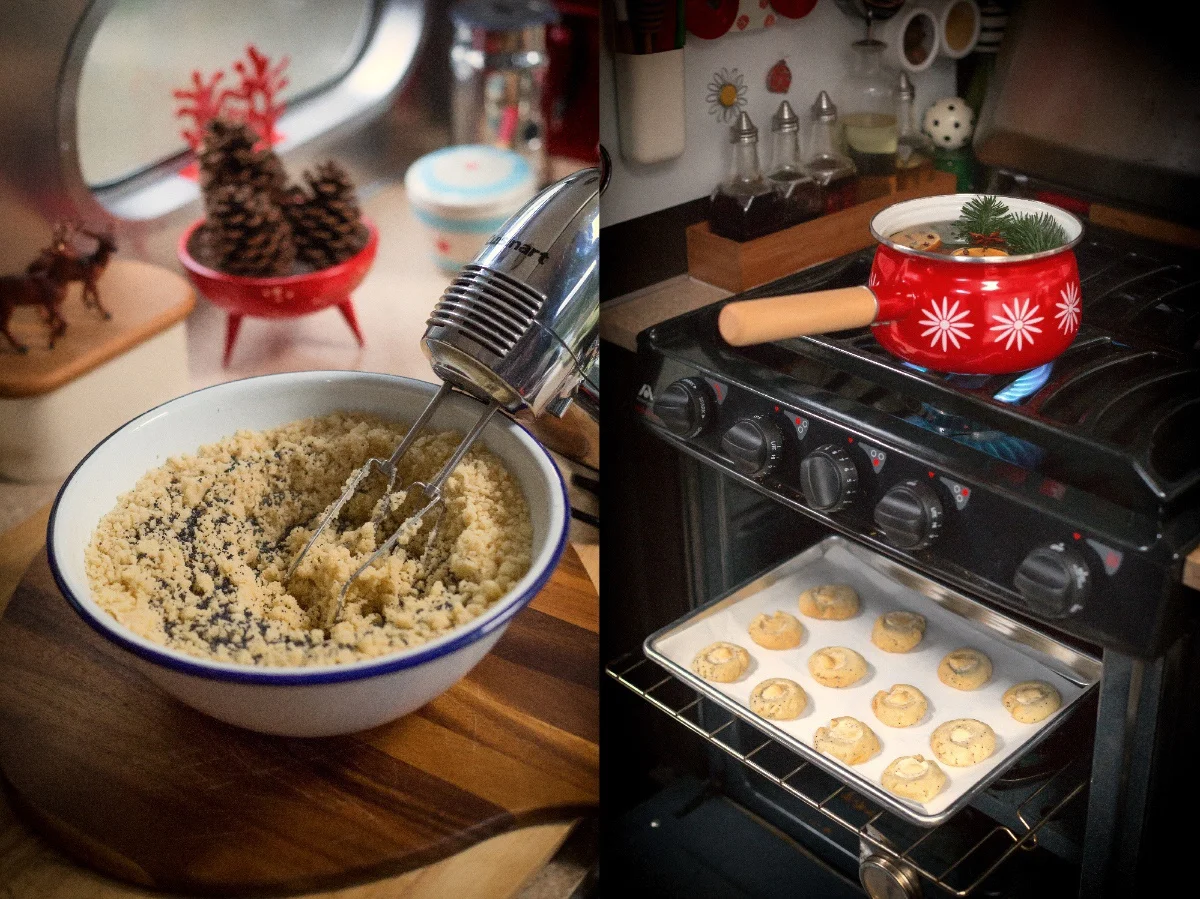Mixer in a bowl of dough beside an oven with baking cookies and a red-patterned pot on the stove, creating a cozy kitchen scene.