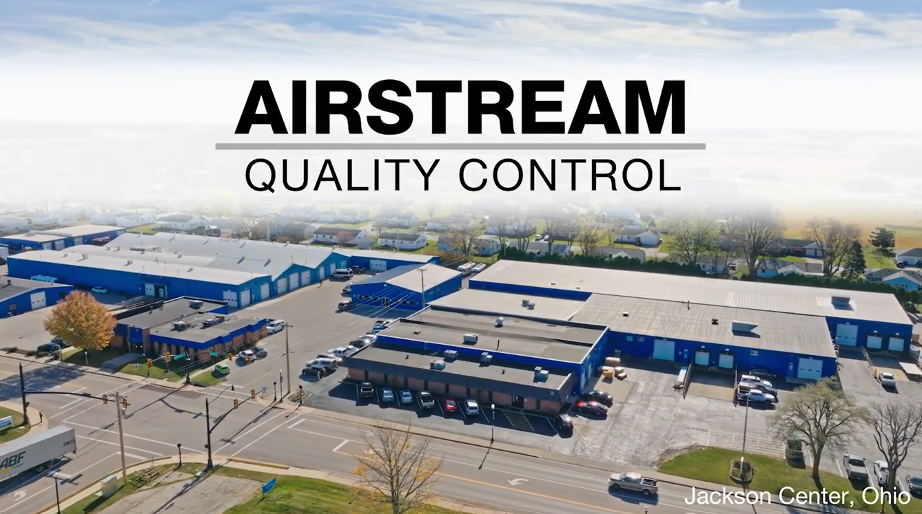 Aerial view of an industrial facility with "AIRSTREAM QUALITY CONTROL" text above, located in Jackson Center, Ohio.