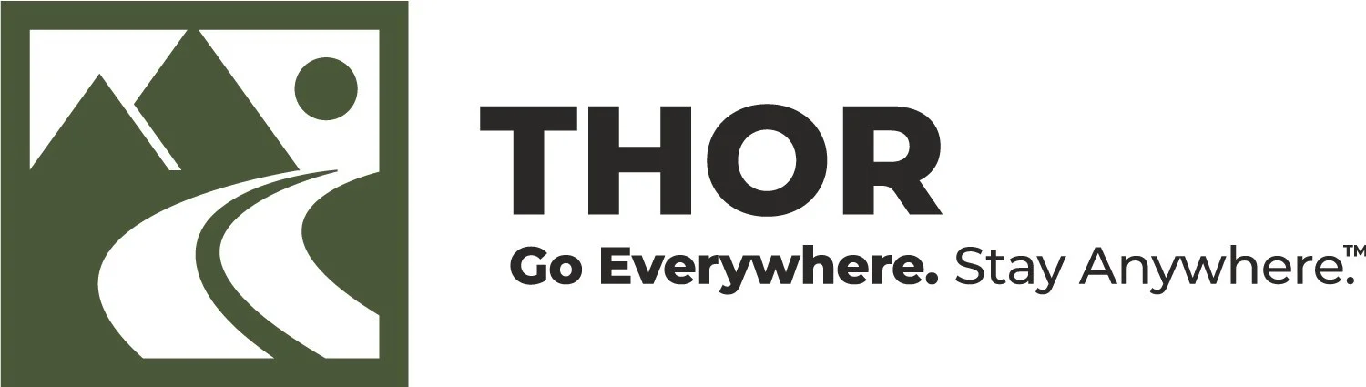 A logo featuring stylized mountains, a road, and a sun inside a green square, next to the words THOR Go Everywhere. Stay Anywhere. in bold black and gray text.