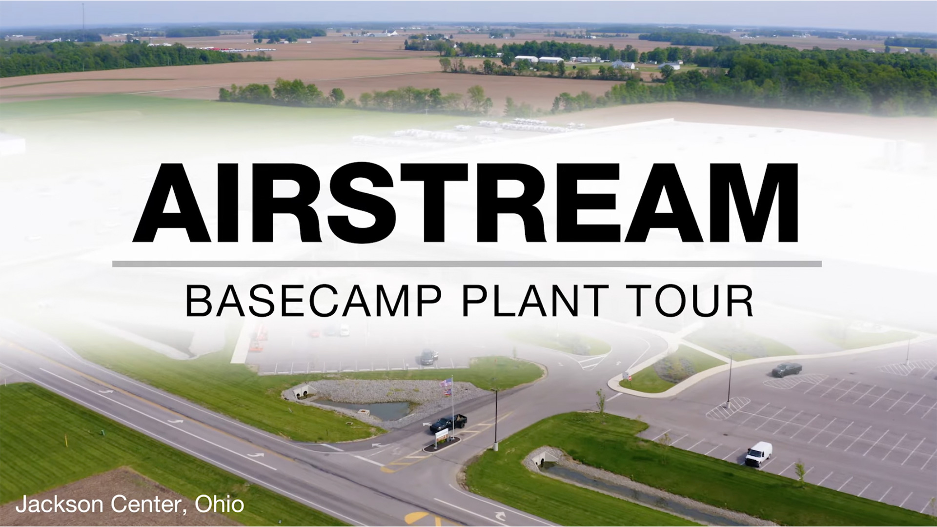 Aerial view of the Airstream Basecamp Plant Tour location in Jackson Center, Ohio, with fields and buildings in the background.