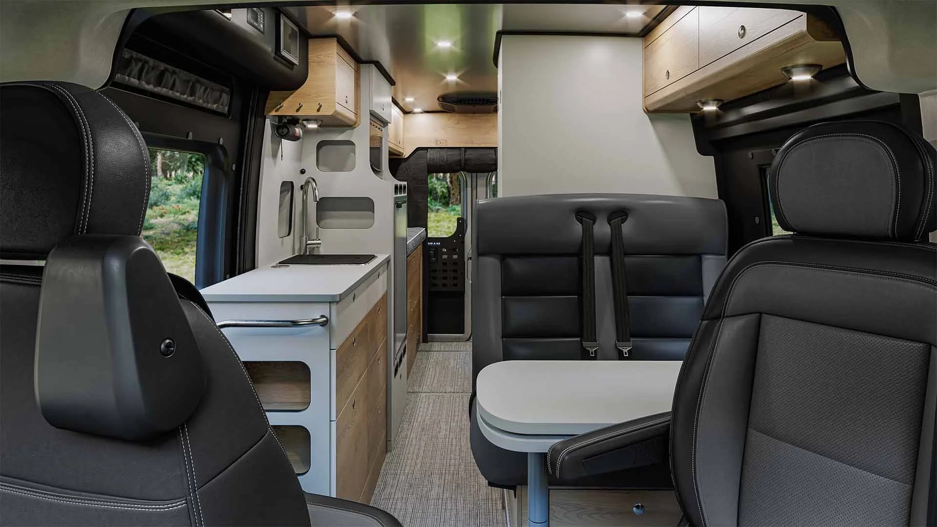 Interior of a modern camper van with leather seats, compact kitchen, overhead storage, and wood accents, offering a cozy, efficient space.