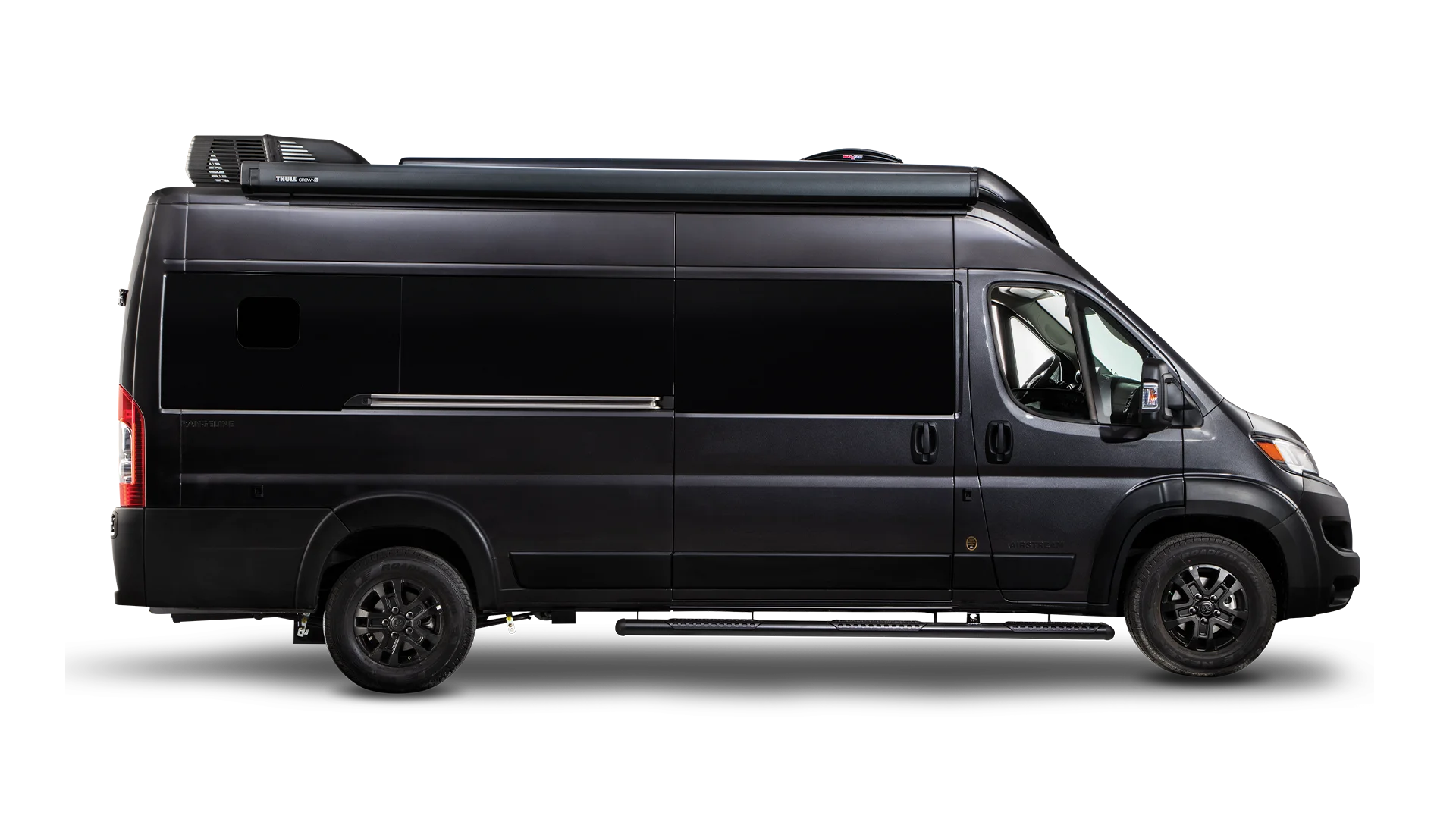 Side view of a sleek black camper van with tinted windows, showcasing its modern design and roof-mounted equipment.