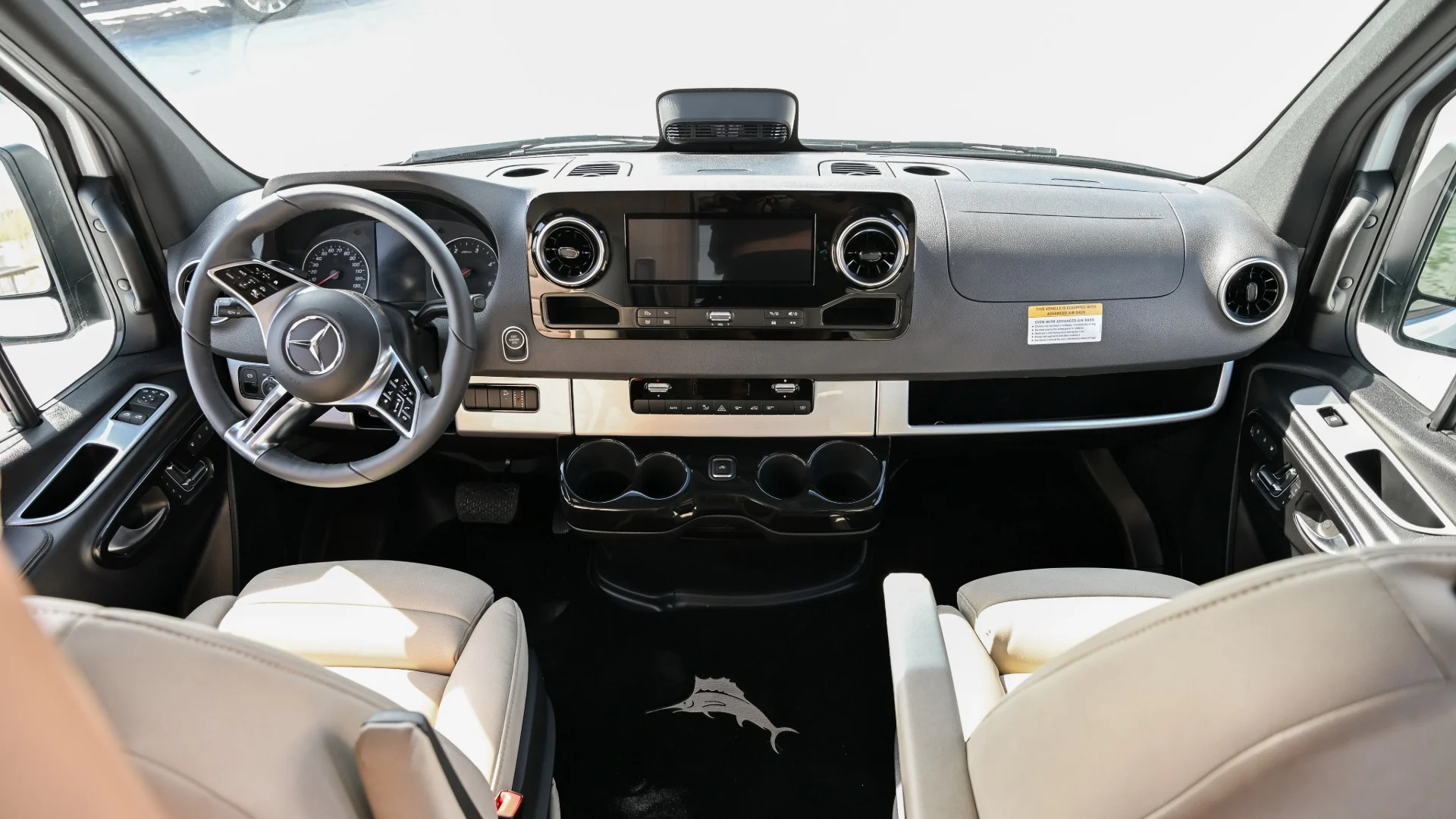 Beige front seats and dash of a Mercedez camper van