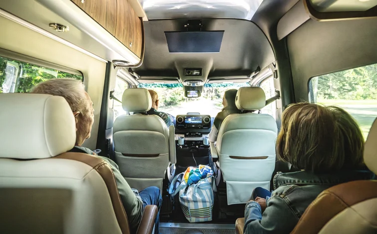 Family riding in two row camper van seats