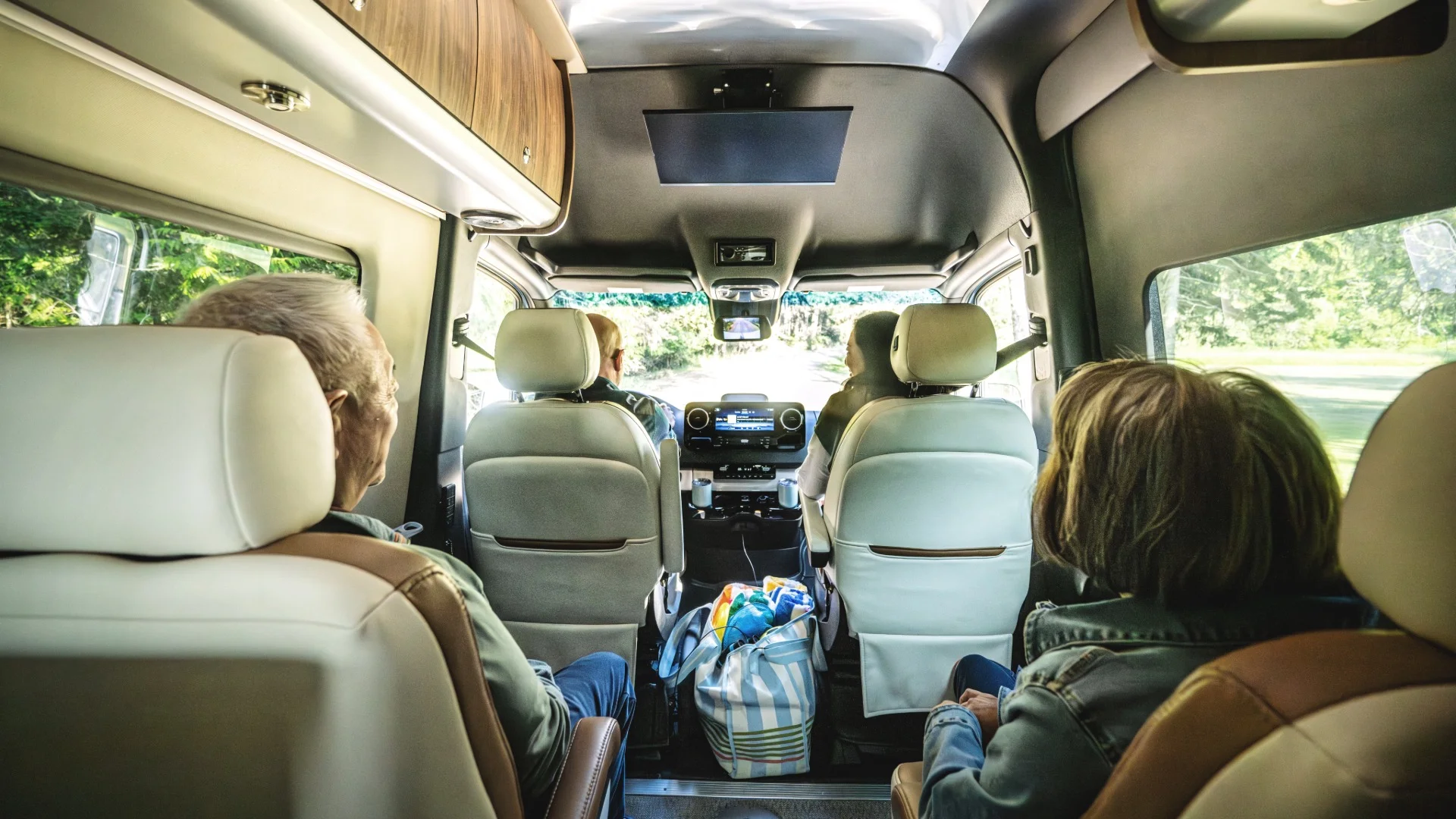 Family riding in two row camper van seats