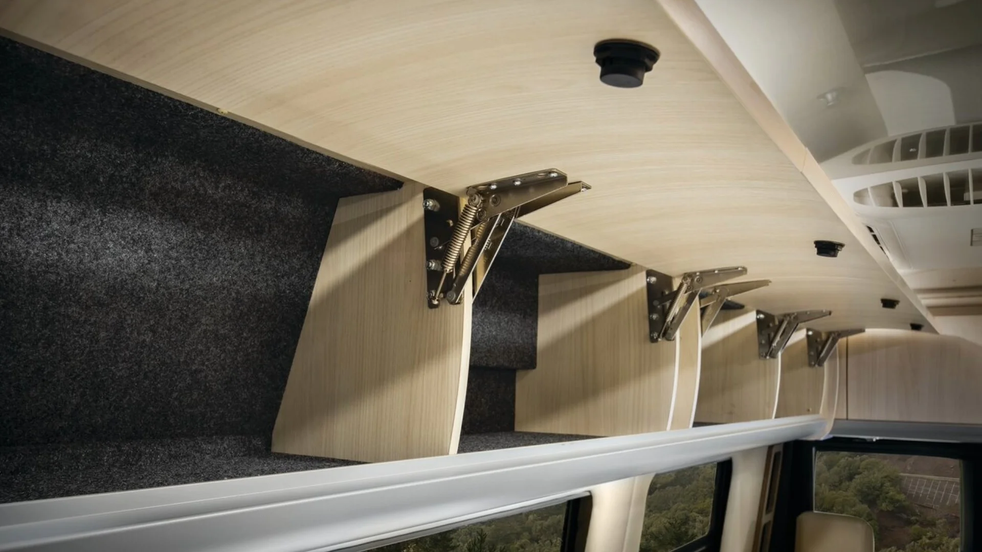 Closeup of overhead storage lockers open with serveral seperate compartments