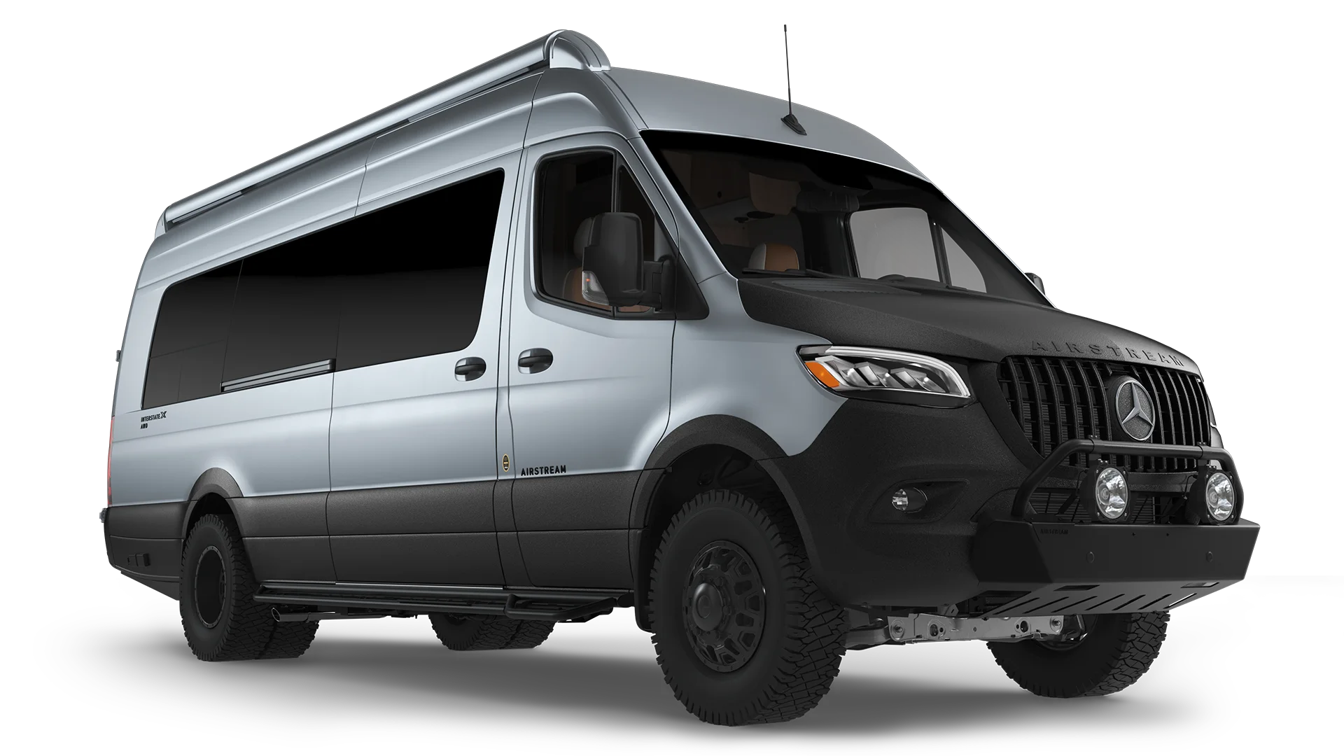 Silver Mercedes-Benz Sprinter van with rugged tires and a black bumper, viewed from a low front angle.
