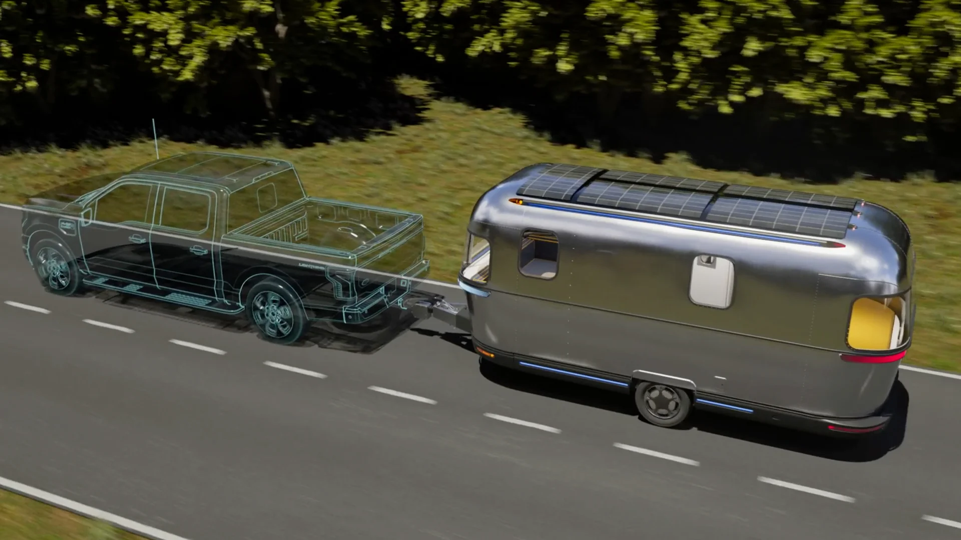 A silver camper with solar panels is towed by a semi-transparent truck on a road lined with green trees.