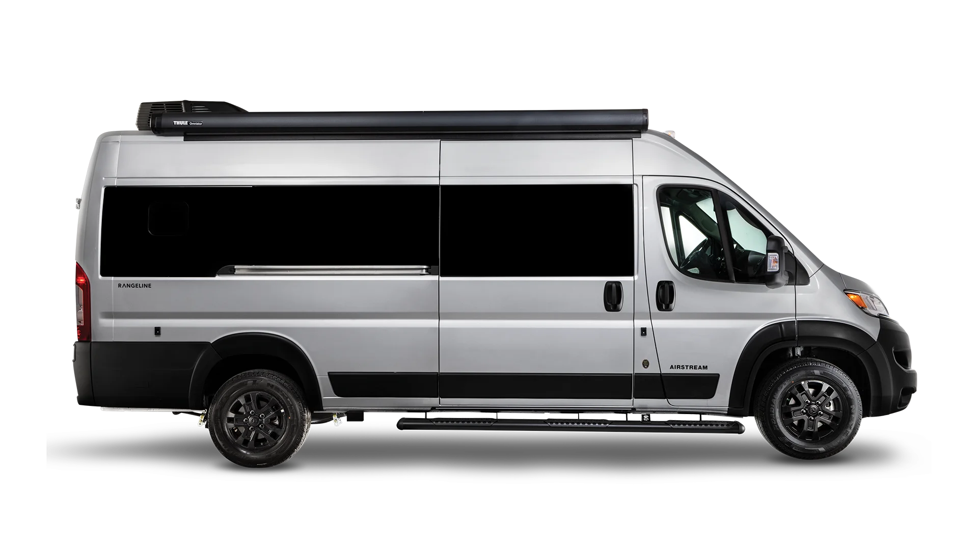 A silver camper van with a retractable awning on top, viewed from the side, against a plain white background.