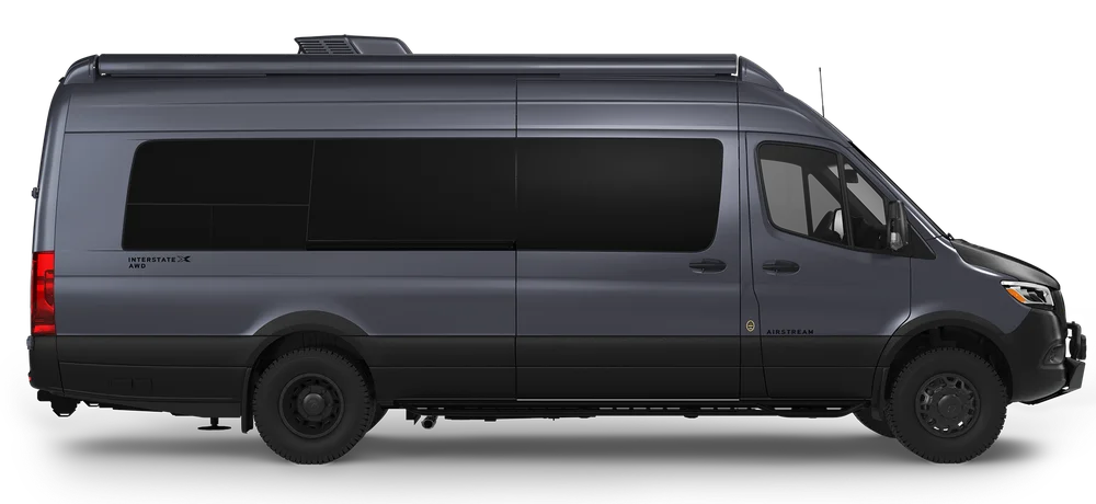 Side view of a sleek, dark gray van with tinted windows and a streamlined roof, designed for comfortable travel or living.