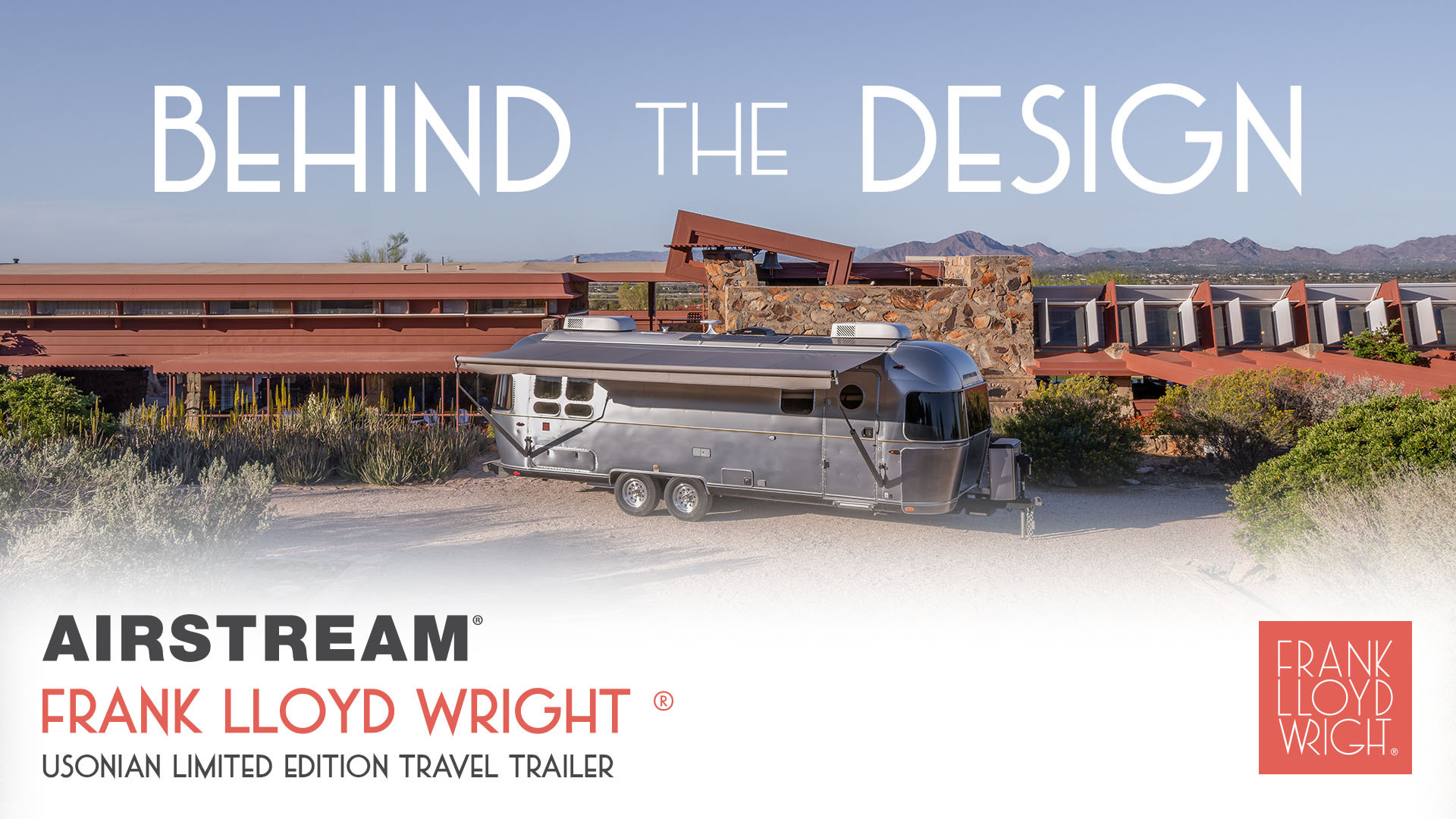 Shiny travel trailer parked in front of modern architecture with a desert backdrop, showcasing Airstream and Frank Lloyd Wright design collaboration.