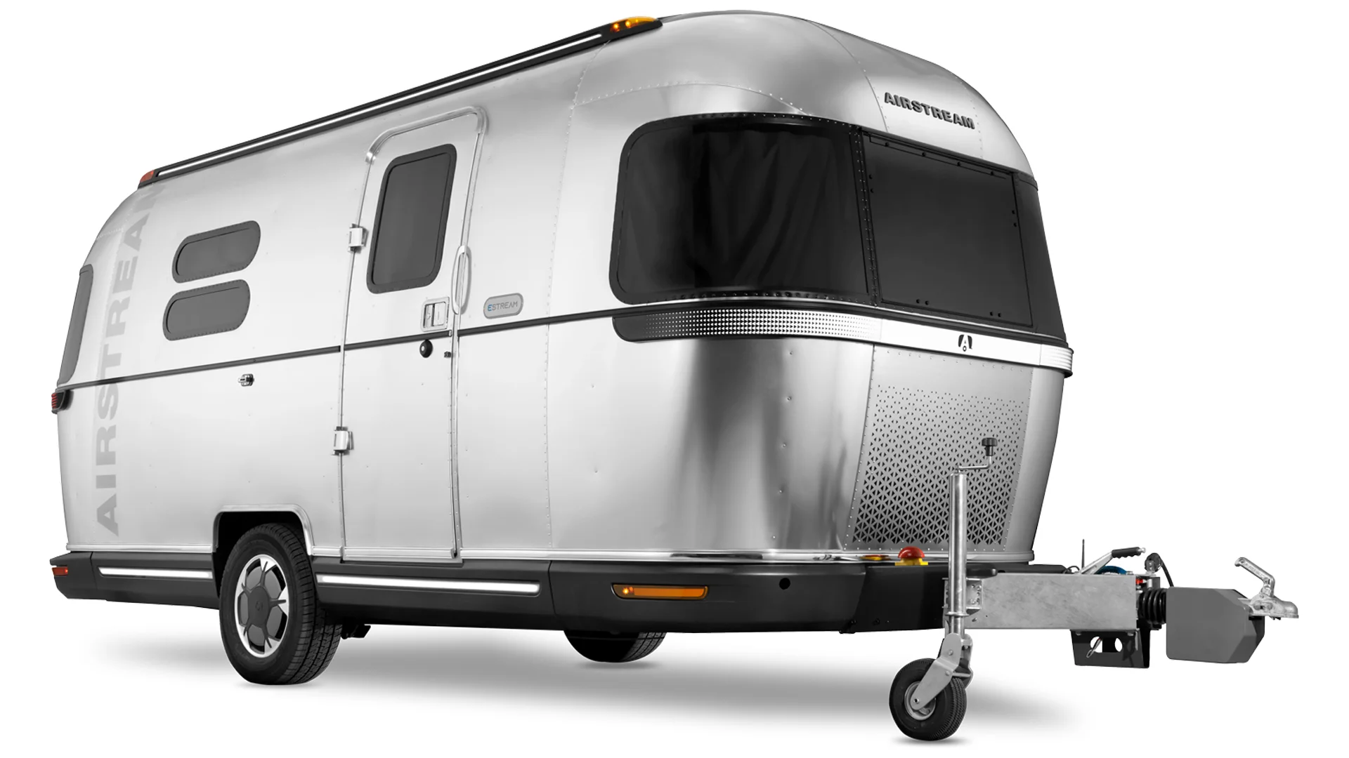 A shiny silver Airstream travel trailer with rounded edges, two windows, and a single entry door, shown on a white background. The front hitch and wheel are visible in the foreground.