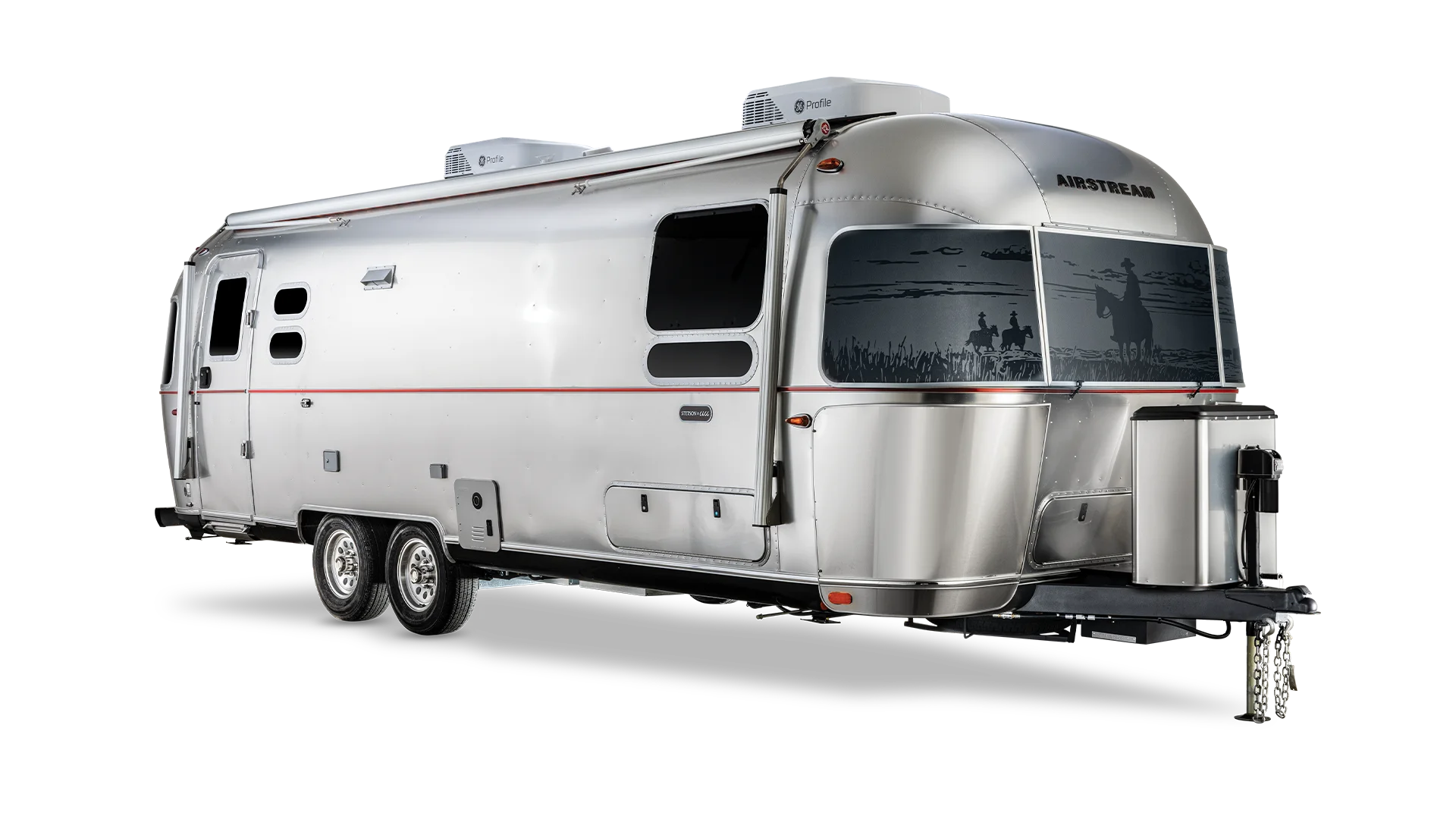 Silver Airstream travel trailer with a sleek design, two axles, and rooftop air conditioning units, viewed from the side.