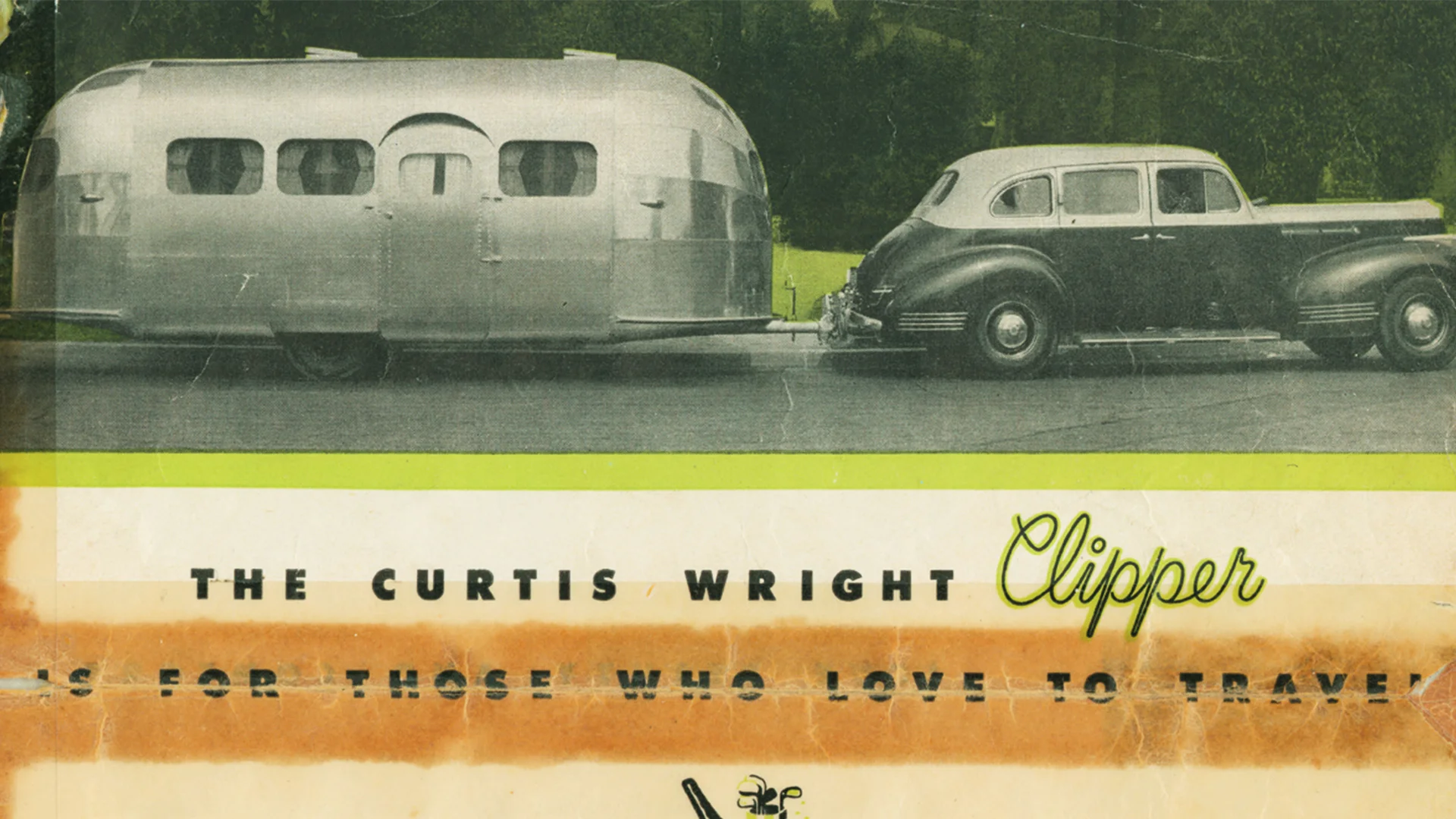A vintage Curtis Wright Clipper travel trailer is hitched to a classic black car, parked on a road with trees in the background. The image has aged, with visible creases and faded colors.