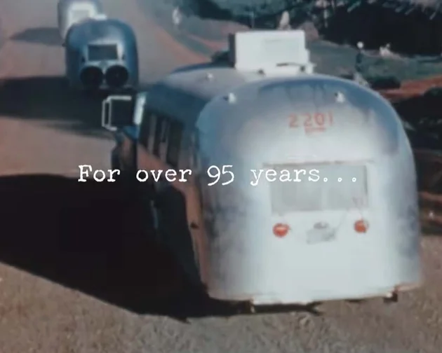 A vintage silver trailer is driving on a dirt road, with text overlay reading "For over 95 years..." in white letters.
