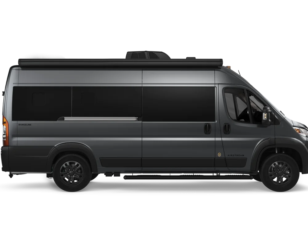 Side view of a dark gray Rangeline 21PL touring coach with tinted windows.