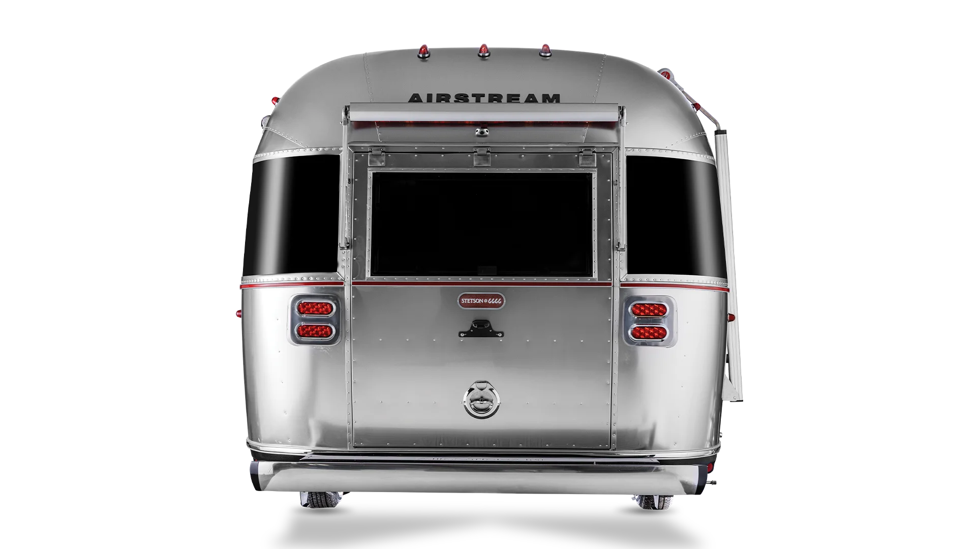 Rear view of a classic Airstream trailer with a silver metallic finish, featuring rounded edges, rear windows, and lights.