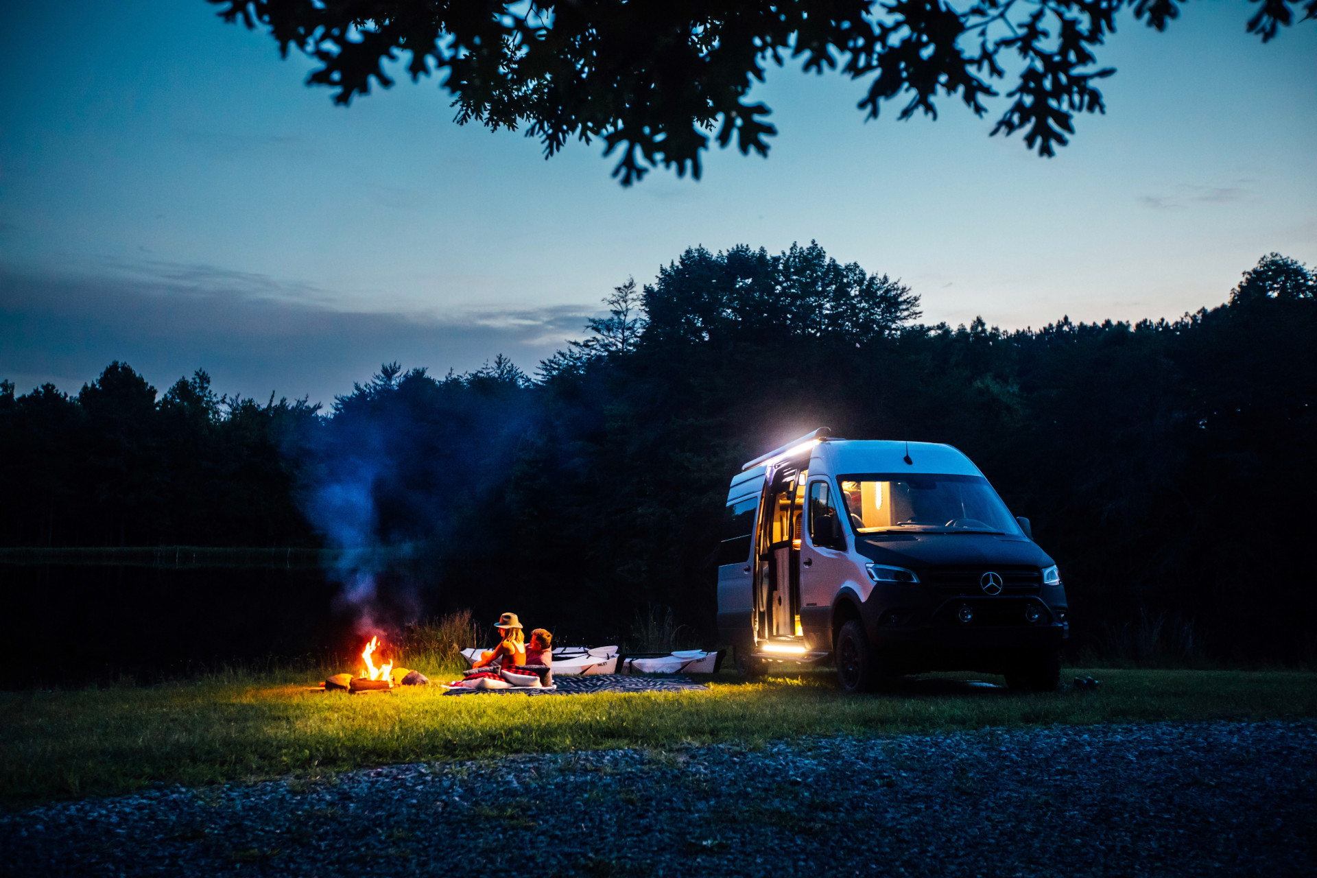 A couple sitting next to a campfire at night next to their Airstream Interstate 19X Class B Motorhome|Airstream Interstate 19X 1|Airstream Interstate 19X 2|Airstream Interstate 19X 3|Airstream Interstate 19X 4|Airstream Interstate 19X 5|Airstream Interstate 19X 6|An Airstream Interstate 19X Class B Motorhome driving down the road in the fog|A man and woman kayaking in a lake next to the Airstream Interstate 19X Class B Motorhome|The galley of the Airstream Interstate 19X Class B Motorhome|The lavy of the Airstream Interstate 19X LE Outland Edition Class B Motorhome|The floor plan of the Airstream Interstate 19X Class B Motorhome|The bed of the Airstream Interstate 19X Class B Motorhome|The front to back interior view of the Airstream Interstate 19X Class B Motorhome|Curbside view of the Airstream Interstate 19X Class B Motorhome|The exterior badge of the Airstream Interstate 19X Class B Motorhome|The interior of the Airstream Interstate 19X Class B Motorhome|A man and woman laying in bed of their Airstream Interstate 19X Class B Motorhome|A woman cooking while a man works on his computer in the Airstream Interstate 19X Class B Motorhome|Airstream Interstate 19X Class B Motorhome parked in a field with kayaks sitting next to it|Airstream Interstate 19X Class B Motorhome driving on a bridge during sunset|Airstream Interstate 19X Class B Motorhome driving through a field|Airstream Interstate 19X Class B Motorhome driving off the road|A man and woman with two coffee cups inside the Airstream Interstate 19X Class B Motorhome.|The Airstream Interstate 19X with the door open