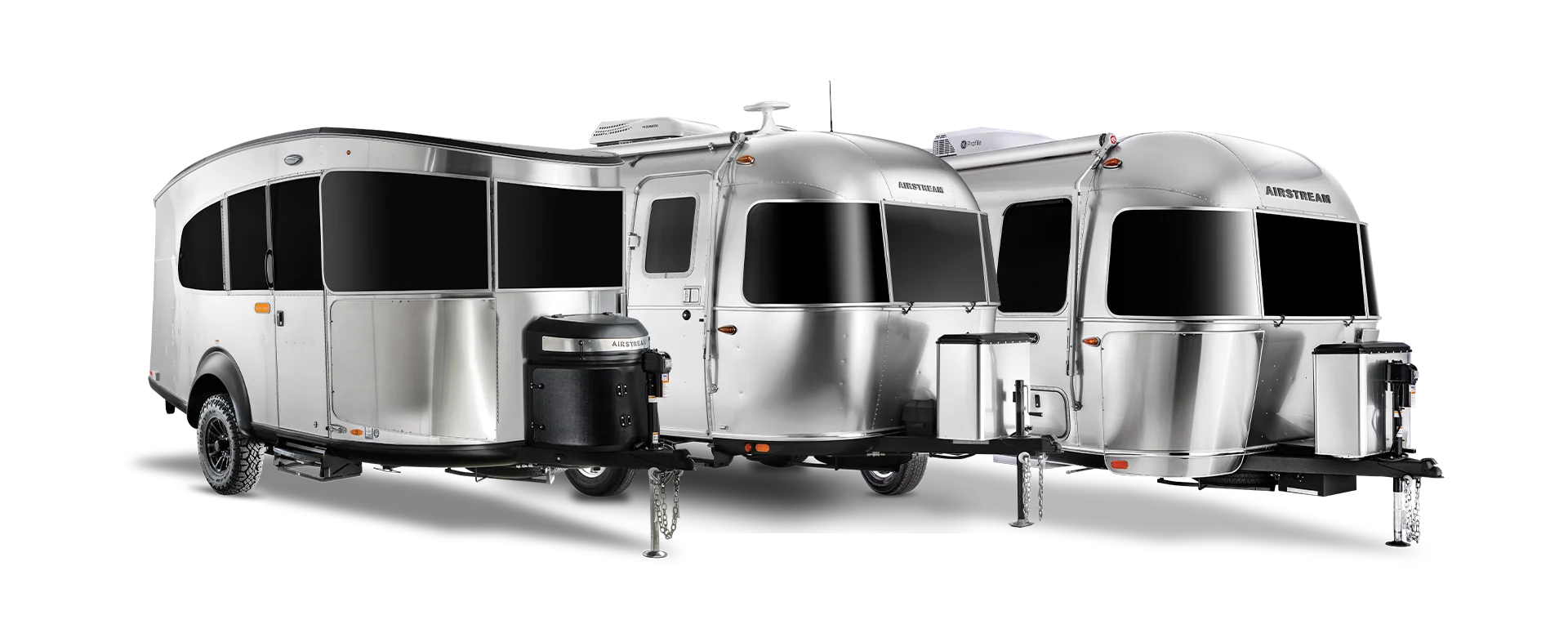 Two sleek, silver Airstream travel trailers side by side, featuring rounded edges and large black-tinted windows.