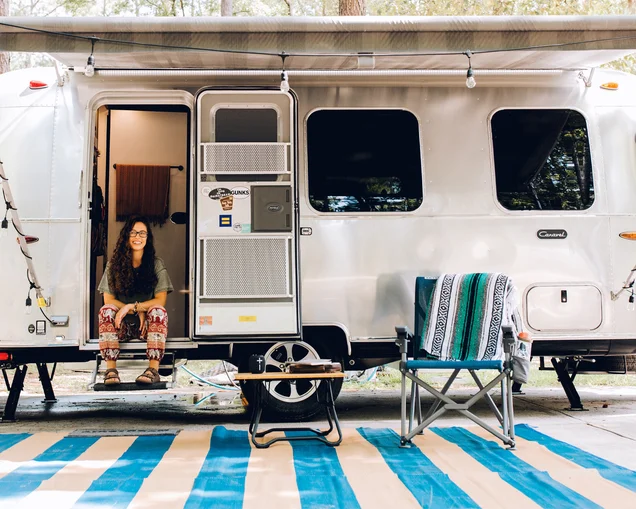 Airstream Ambassador Marisa sitting on the steps of her Airstream Travel Trailer