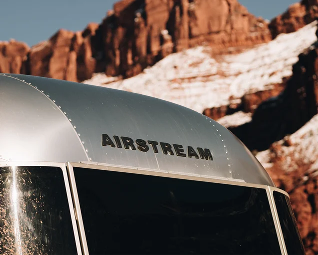 The top badge on an Airstream trailer|BambiCaravel-LP-SupportingAssets-V01-MobileHeader|Airstream-Flying-Cloud-Awning-feature|Airstream-Flying-Cloud-Front-Bunk-Optional-Feature|The top badge on an Airstream trailer