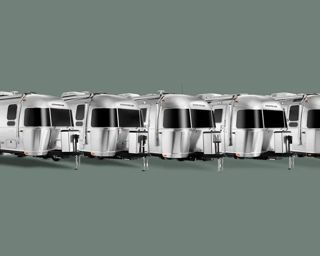 All of Airstream's dual axle travel trailers lined up in a line on a green background.|2023 Airstream International Travel Trailer on a white background|Airstream Globetrotter-Travel-Trailer|All of Airstream's dual axle travel trailers lined up in a line on a green background.|All of Airstream's dual axle travel trailers lined up in a line on a green background.|Trade-Wind-Primary-Image|trade-wind-Answers-to-common-Qs|AIRMKT FLW 2025 1920x1080 3-4 view