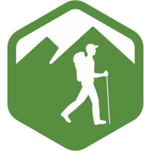 Icon of a person hiking with a backpack and walking stick, set against a green hexagon with mountain peaks in the background.