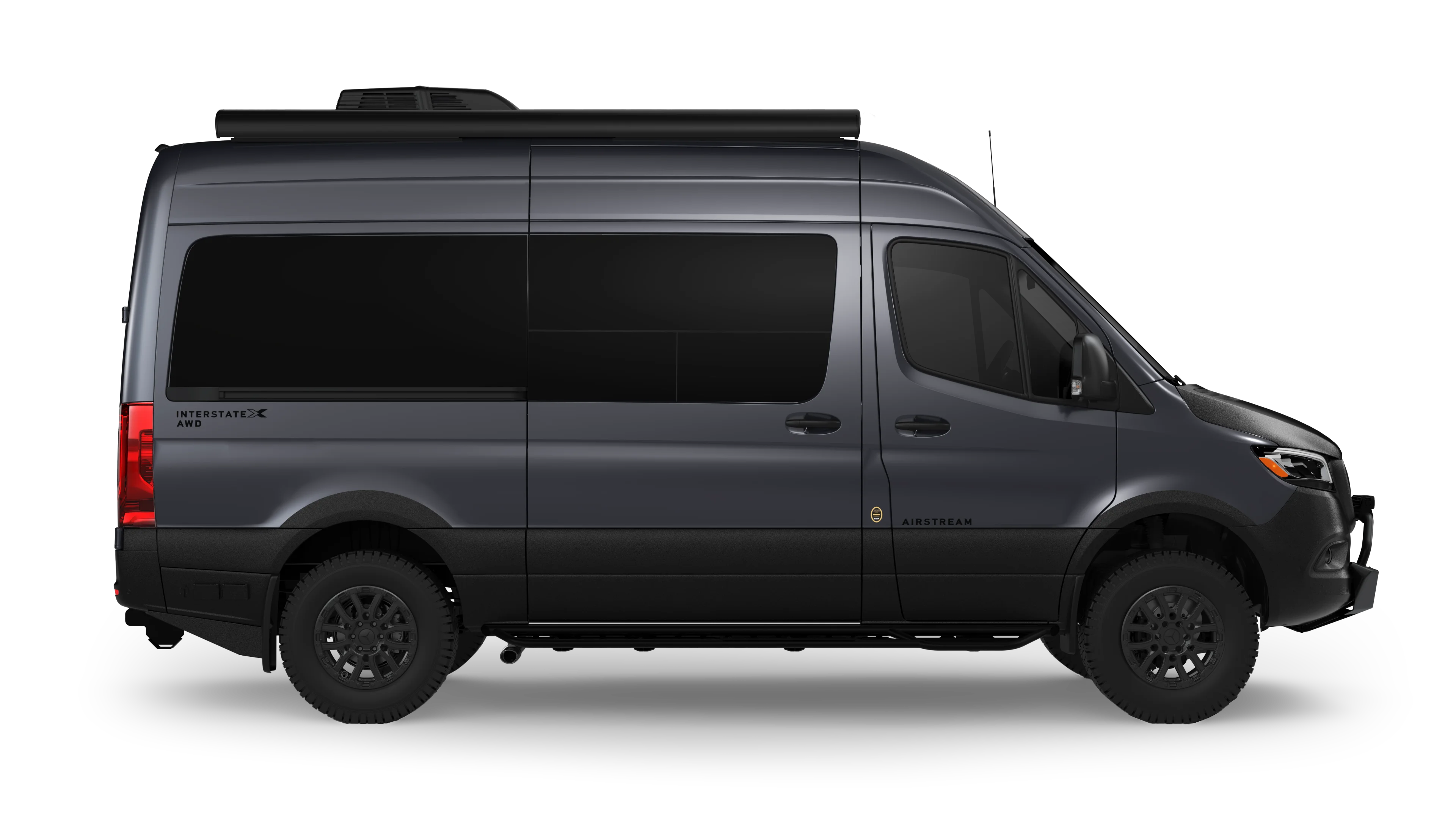 Gray camper van with tinted windows and all-terrain tires, viewed from the side, displaying the inscription "Interstate AWD" and "Airstream."