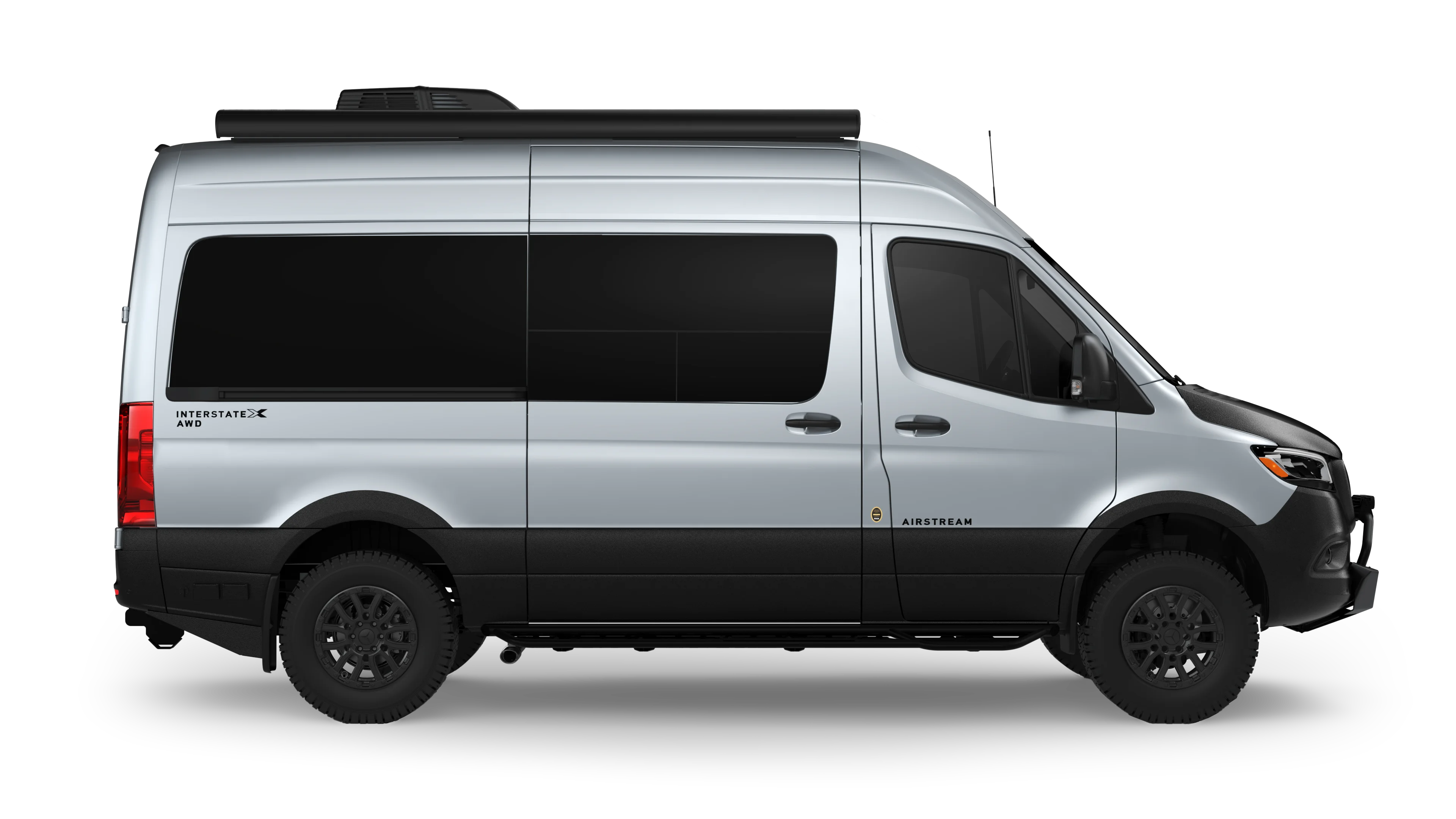 Silver Airstream Interstate van with black accents and all-wheel drive, viewed from the side on a white background.