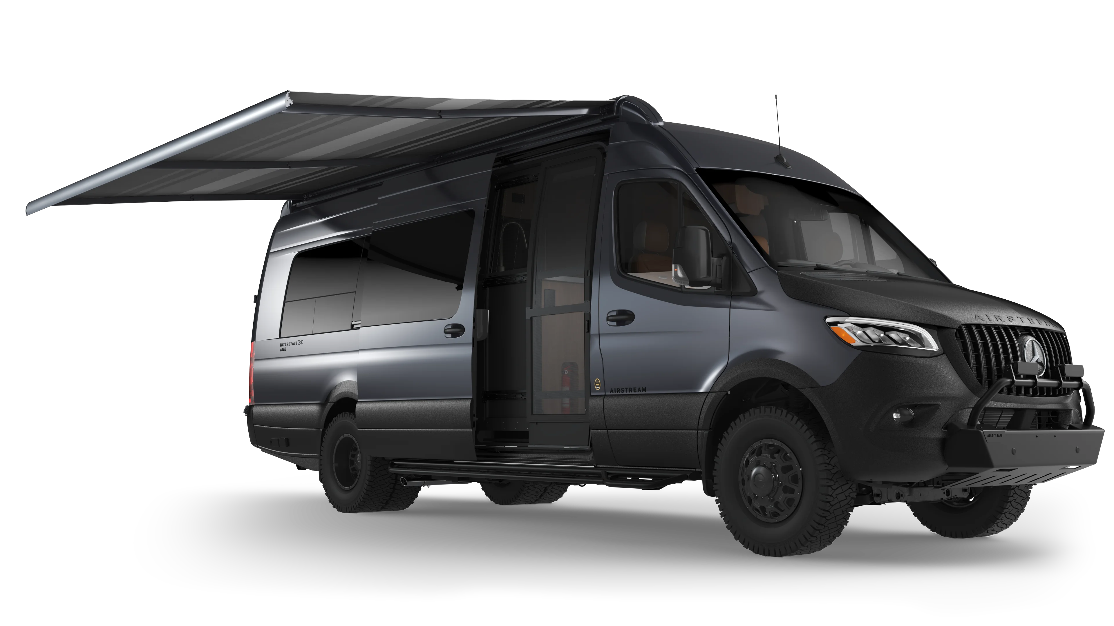 Gray camper van parked with the awning extended and the screen door shut
