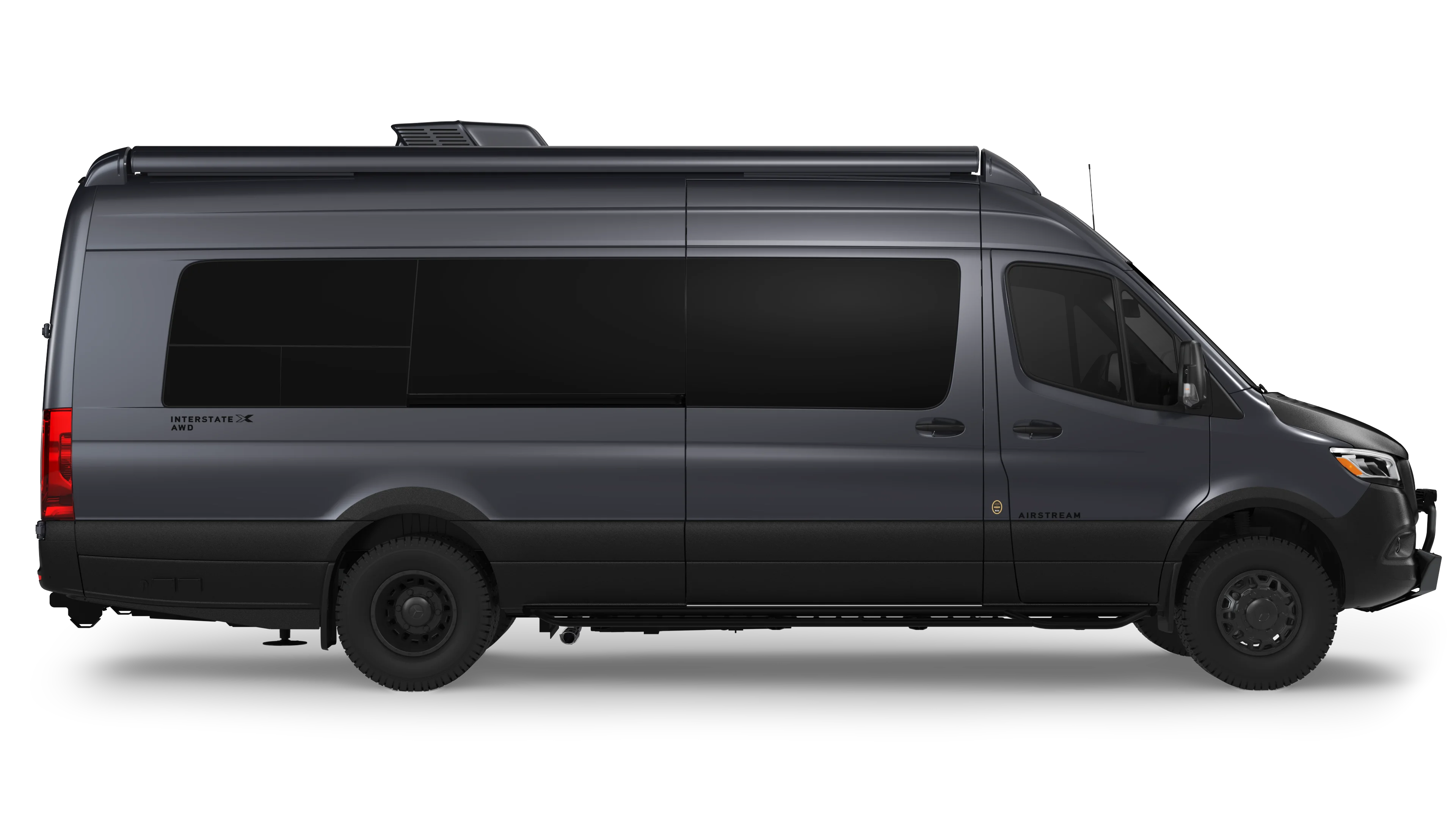 Side view of a sleek dark gray van with tinted windows and all-wheel drive, featuring the Airstream branding on the side.