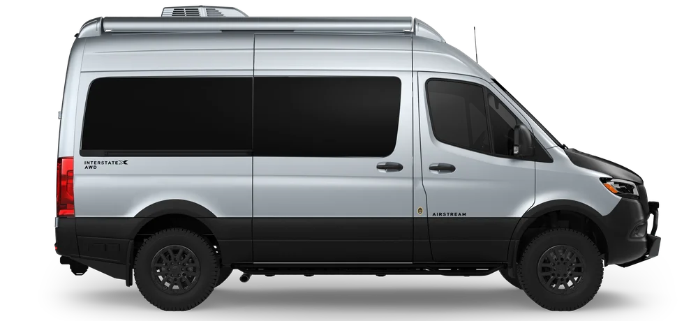 Silver Airstream Interstate AWD van, side view with black accents and tinted windows, set against a plain background.