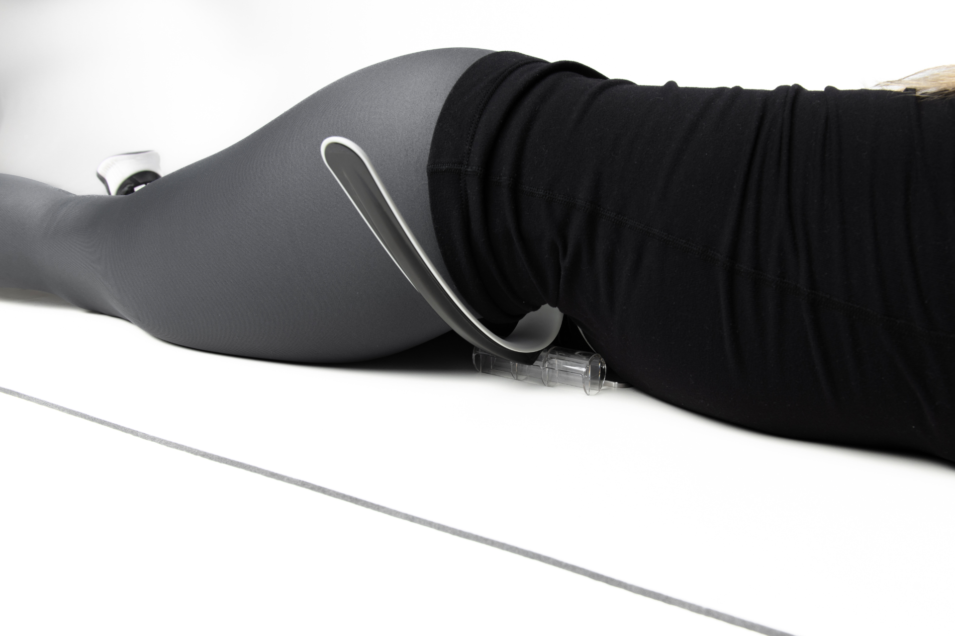 null woman using the Hip Hook muscle release tool for the hip flexors