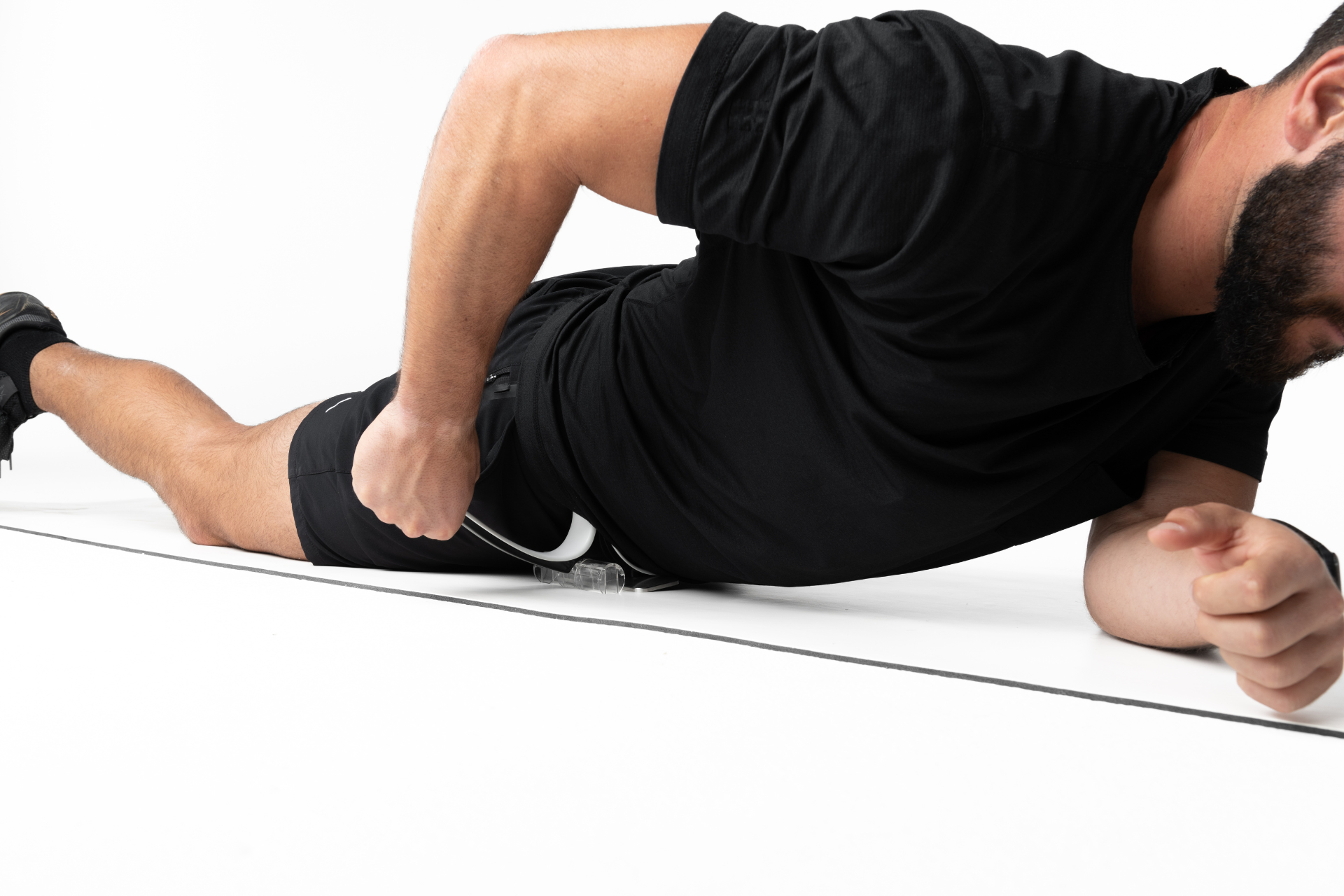 null man massaging the hip flexors using the Hip Hook tool