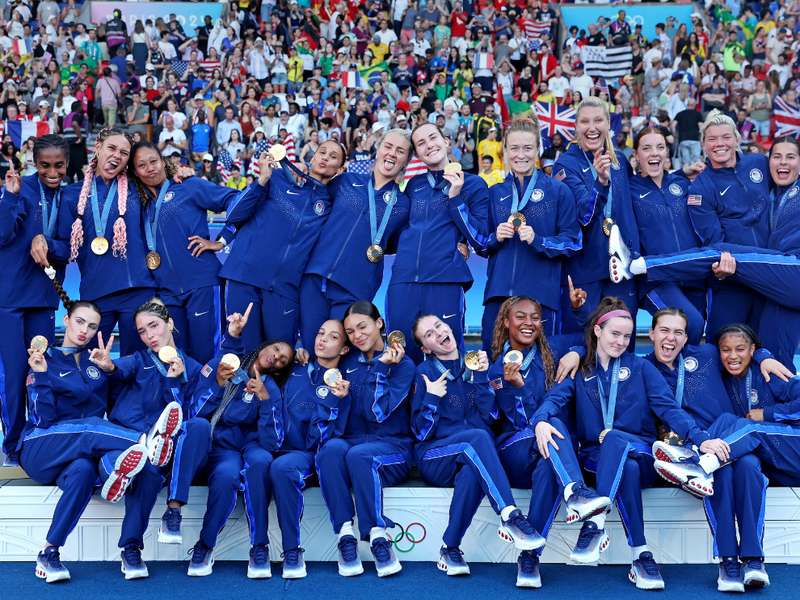United States Women's National soccer team celebrating winning a gold medal at the Olympics.