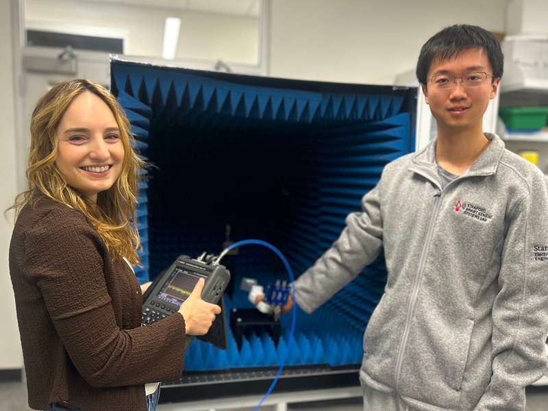 Geneva Ecola and Jida Zhang hold their thermal noise device in a lab